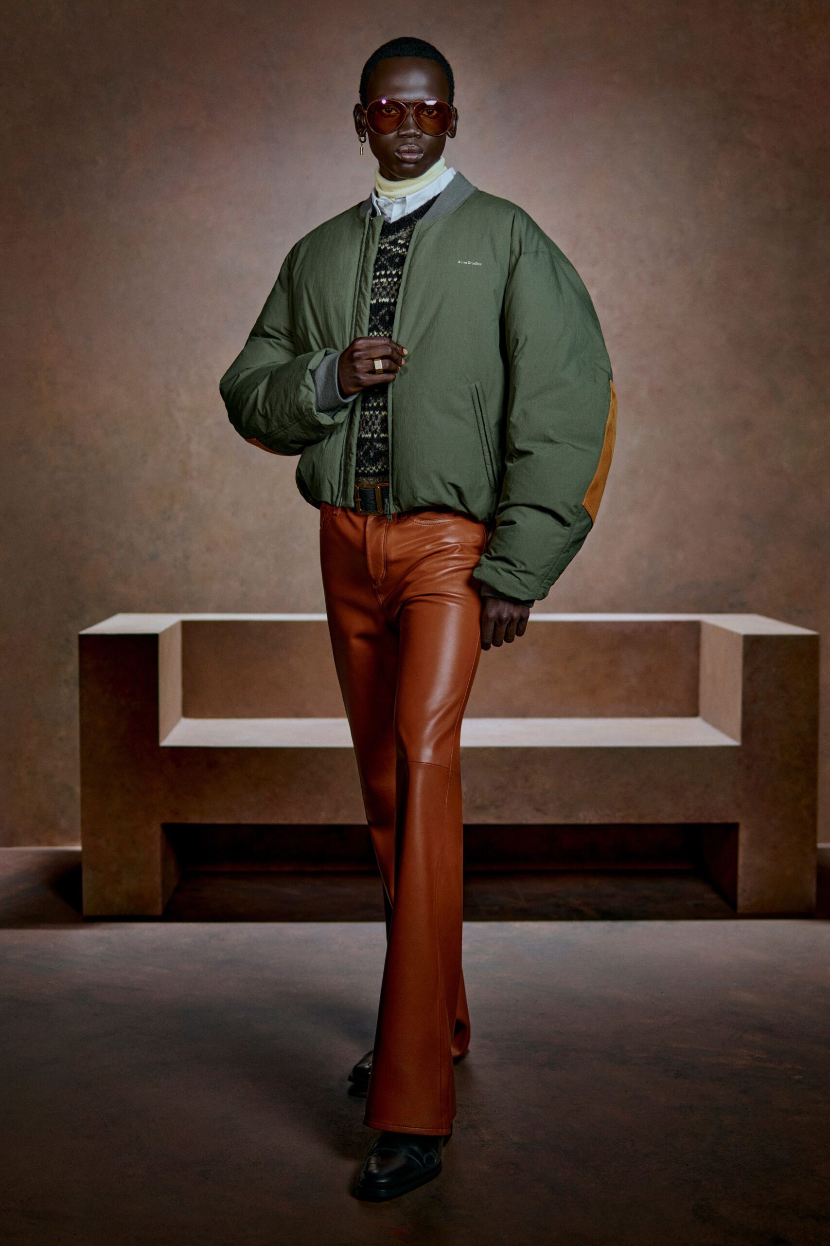 green oversized jacket black sweater orange pants