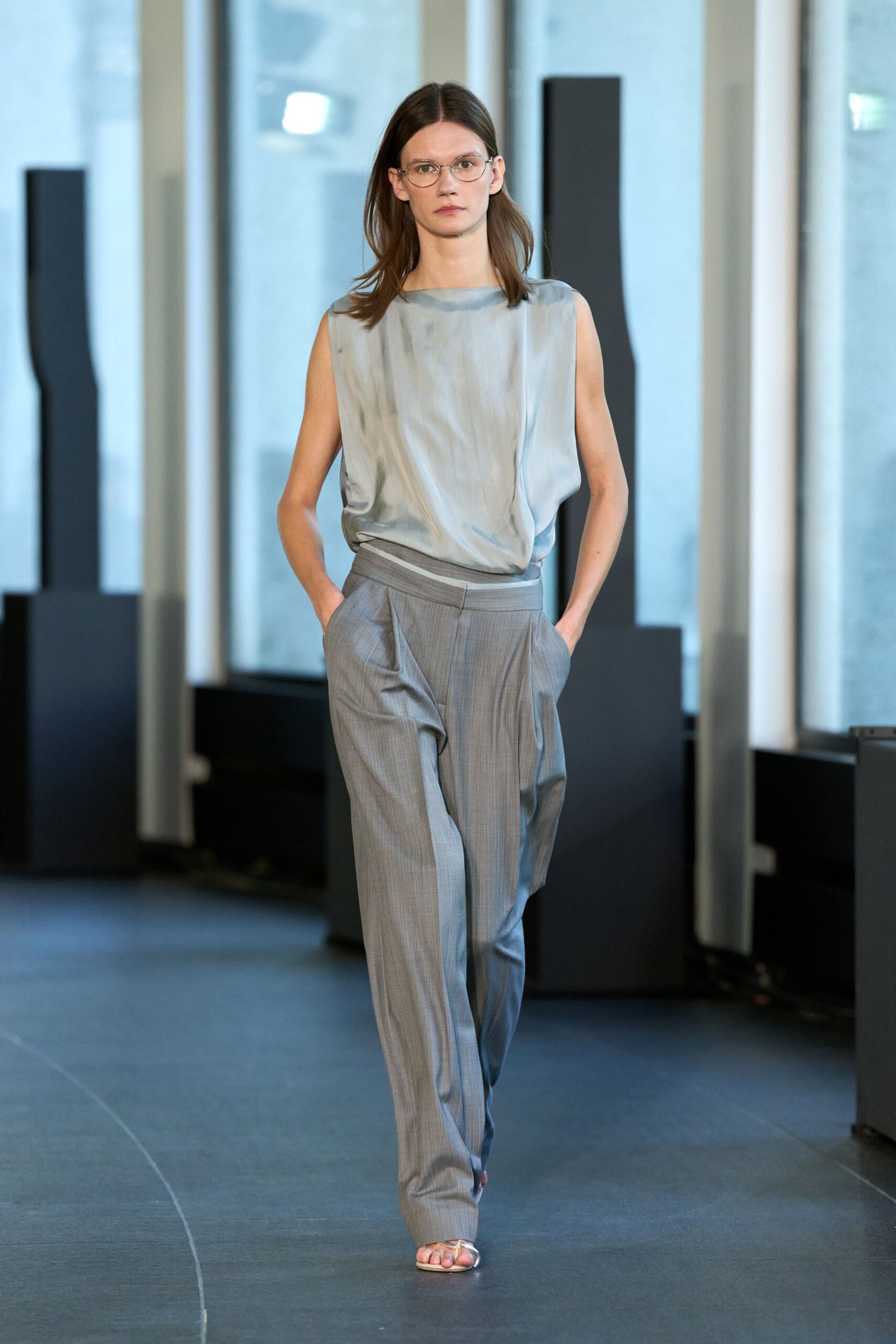 blue silk sleeveless top with gray tailored pants