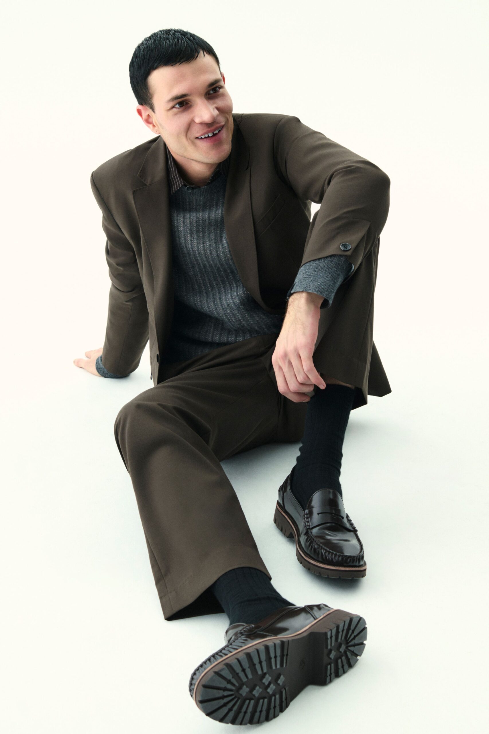 brown tailored suit with gray sweater