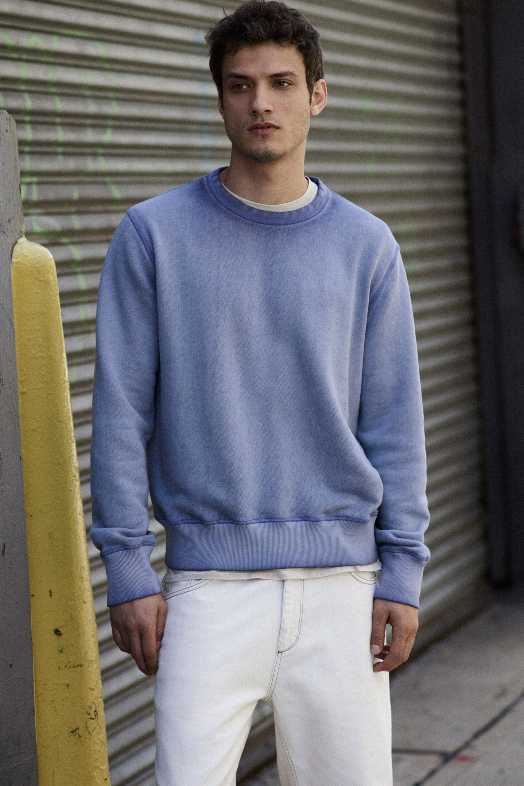 blue relaxed sweater with white pants