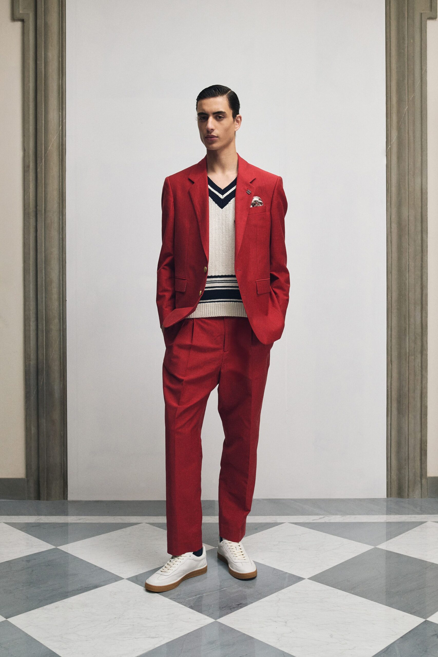 red tailored suit with beige sweater