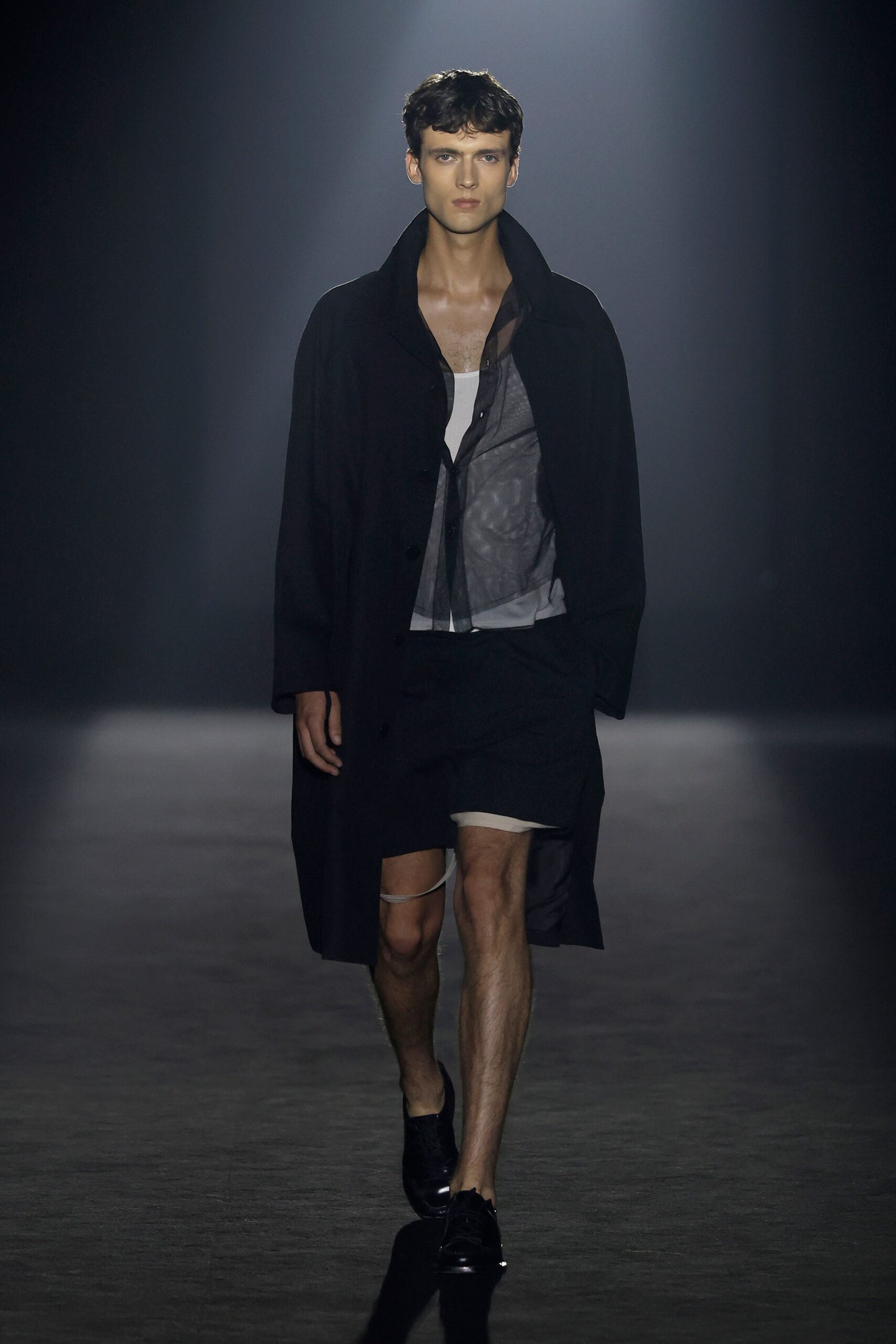 black coat white shirt black shorts