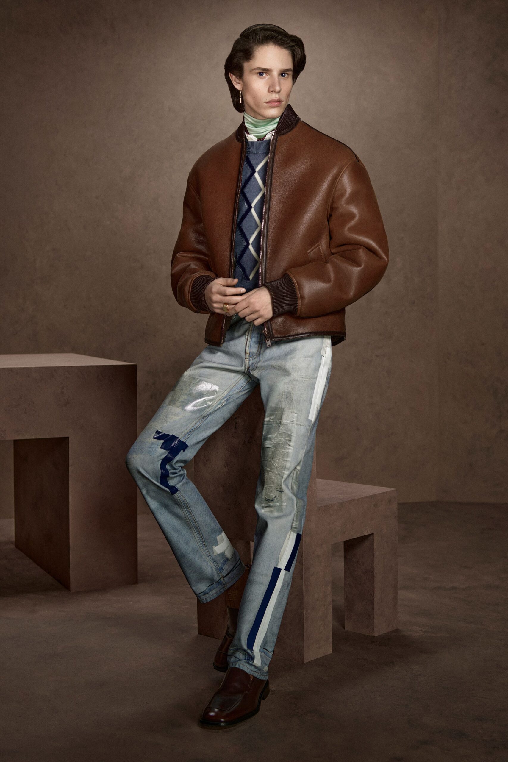 brown leather jacket with sweater and jeans