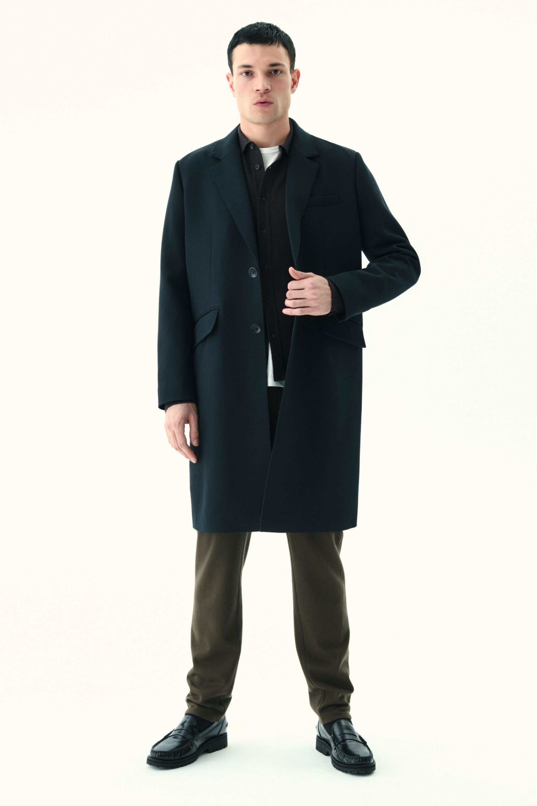 black wool coat with brown pants