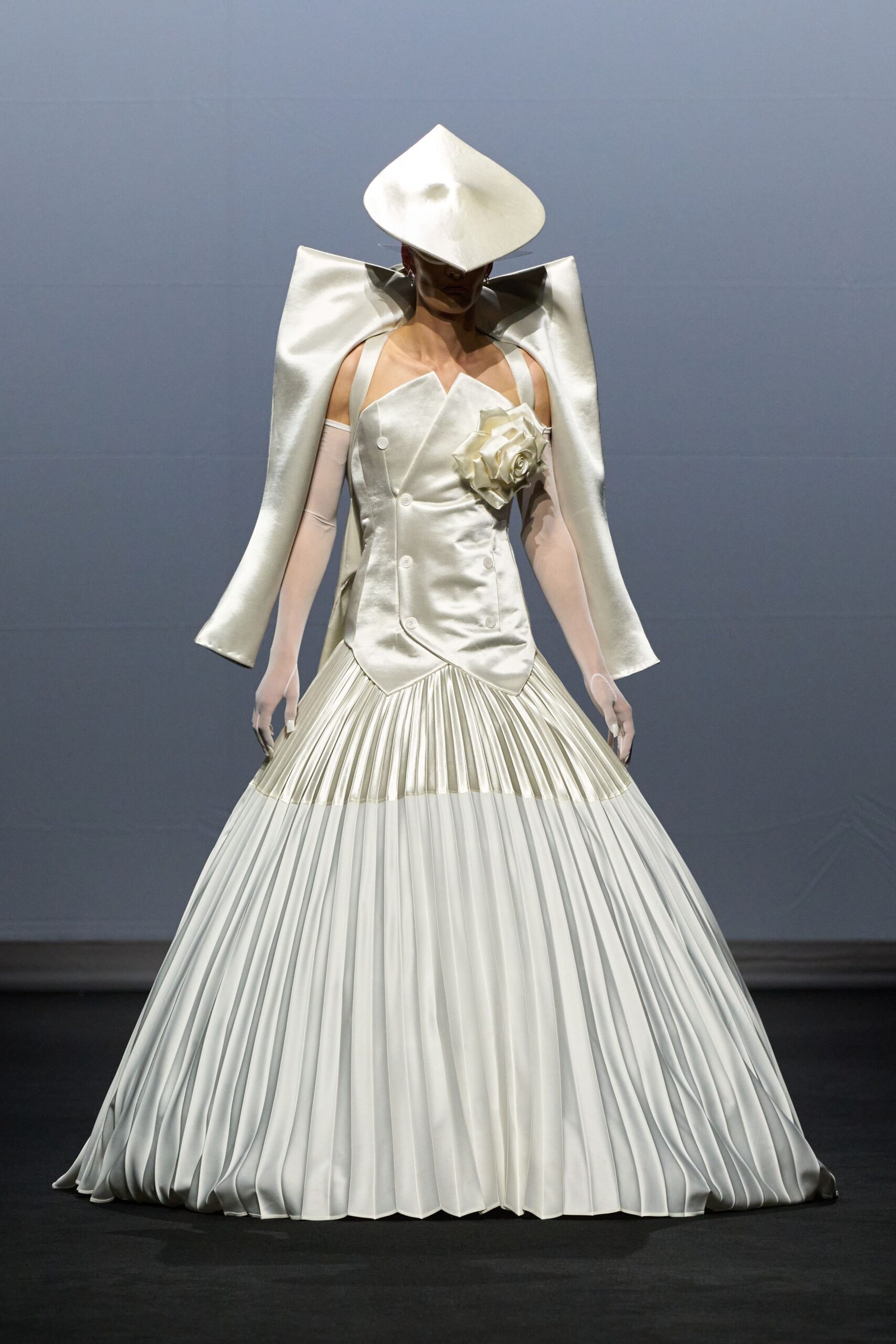 white pleated gown with cape