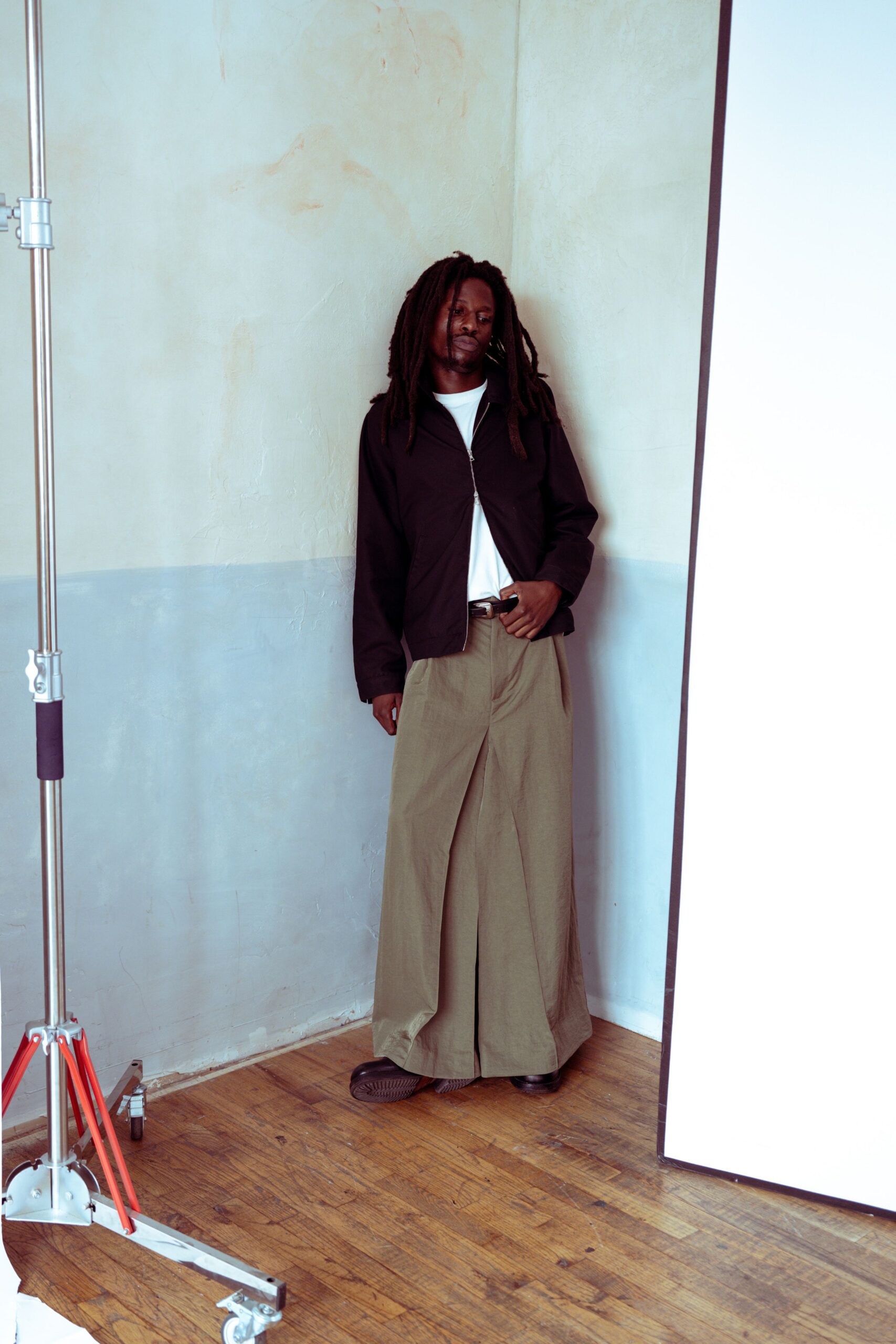 black jacket white t-shirt beige pants