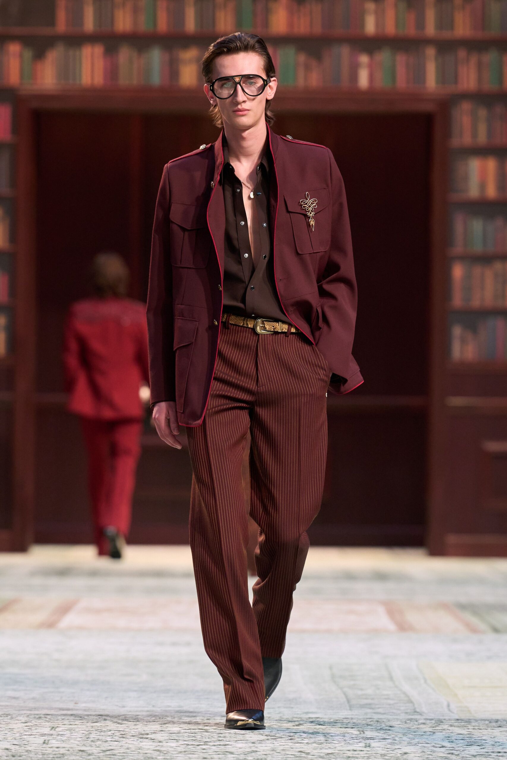 maroon jacket black shirt brown pants