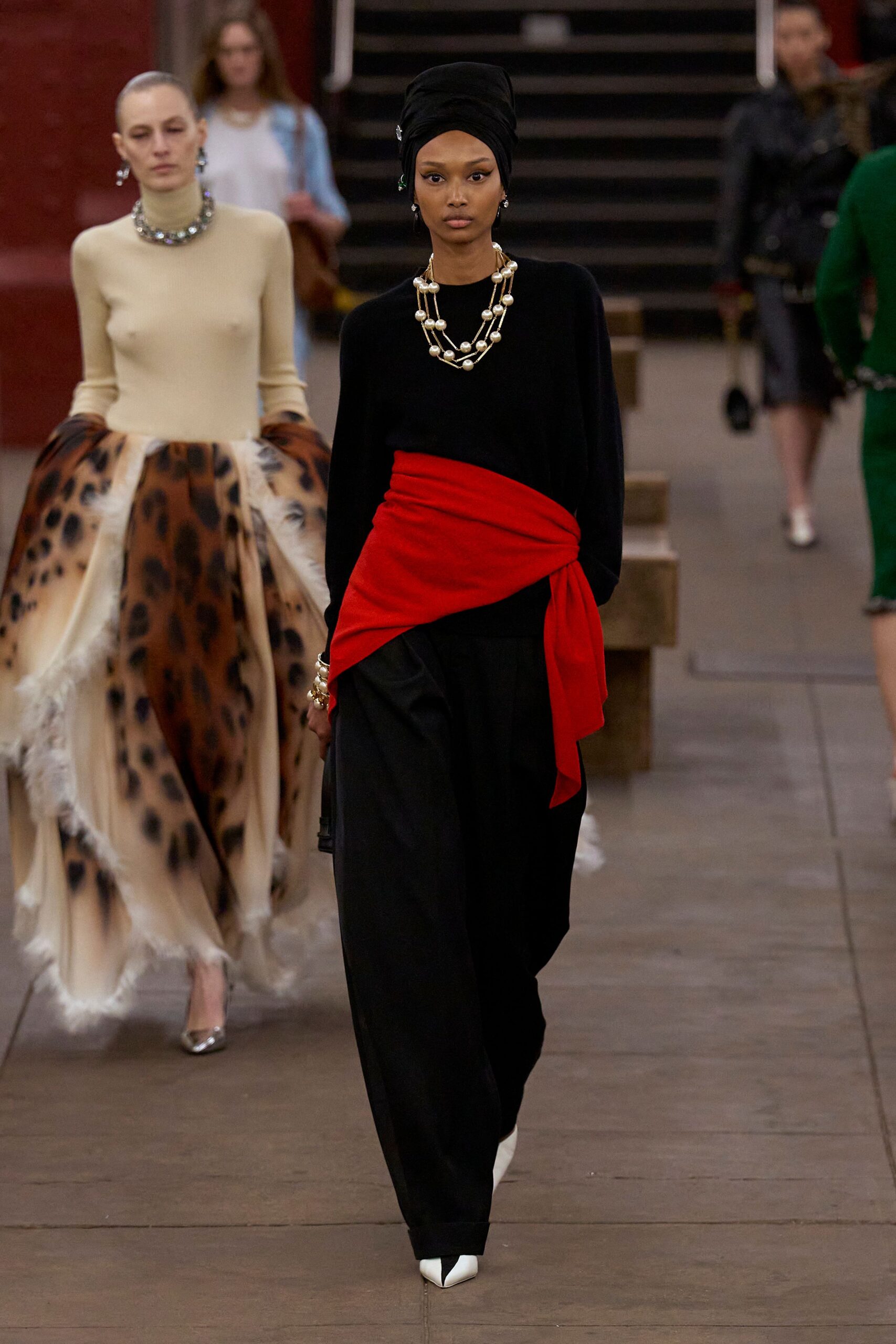 black fitted top with red belt