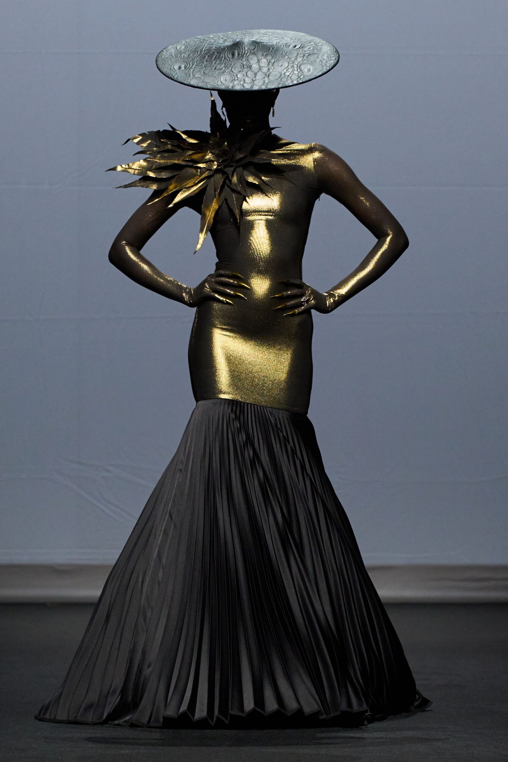 gold and black fitted gown with hat