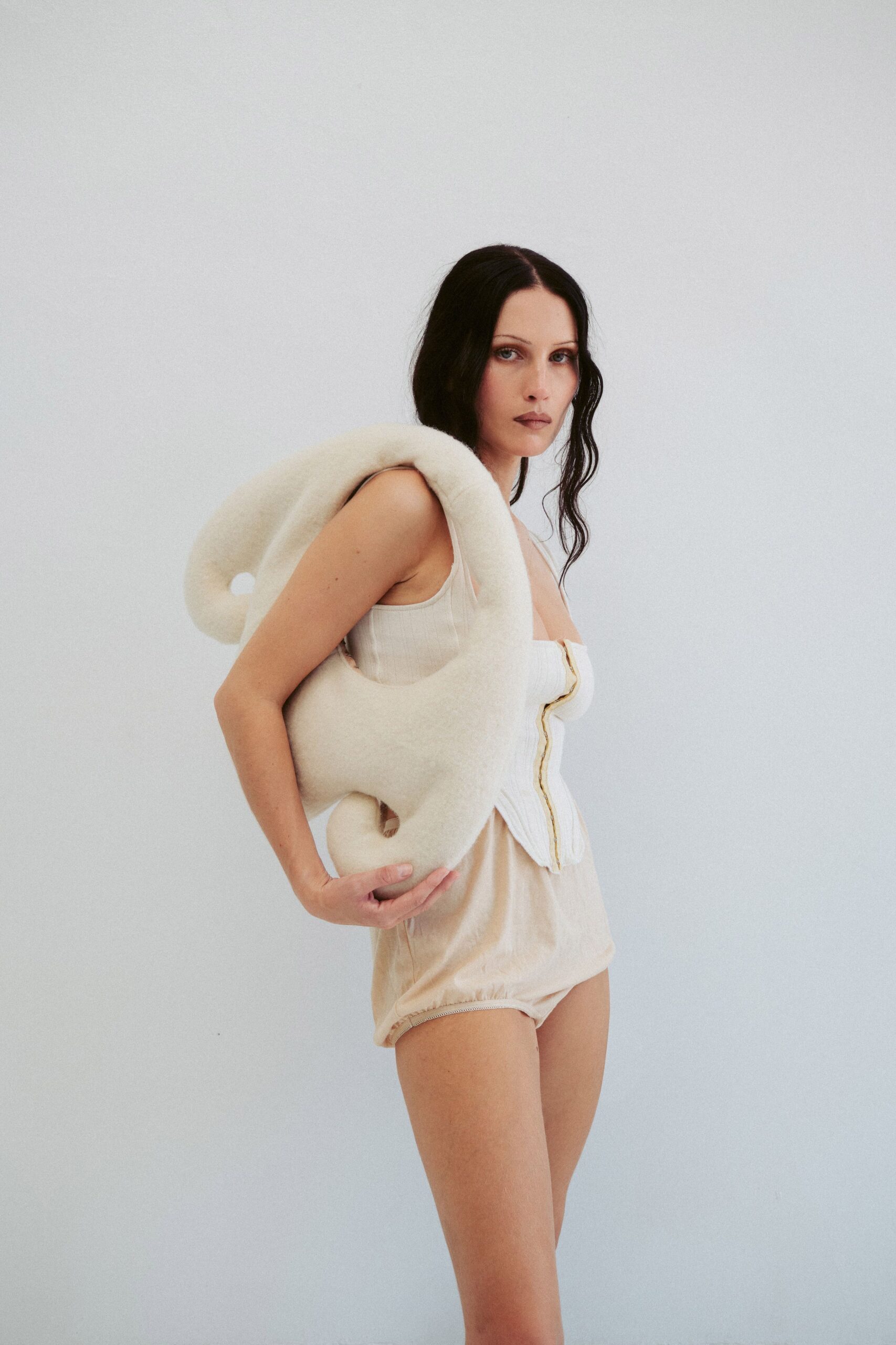 beige fitted bodysuit with white cape