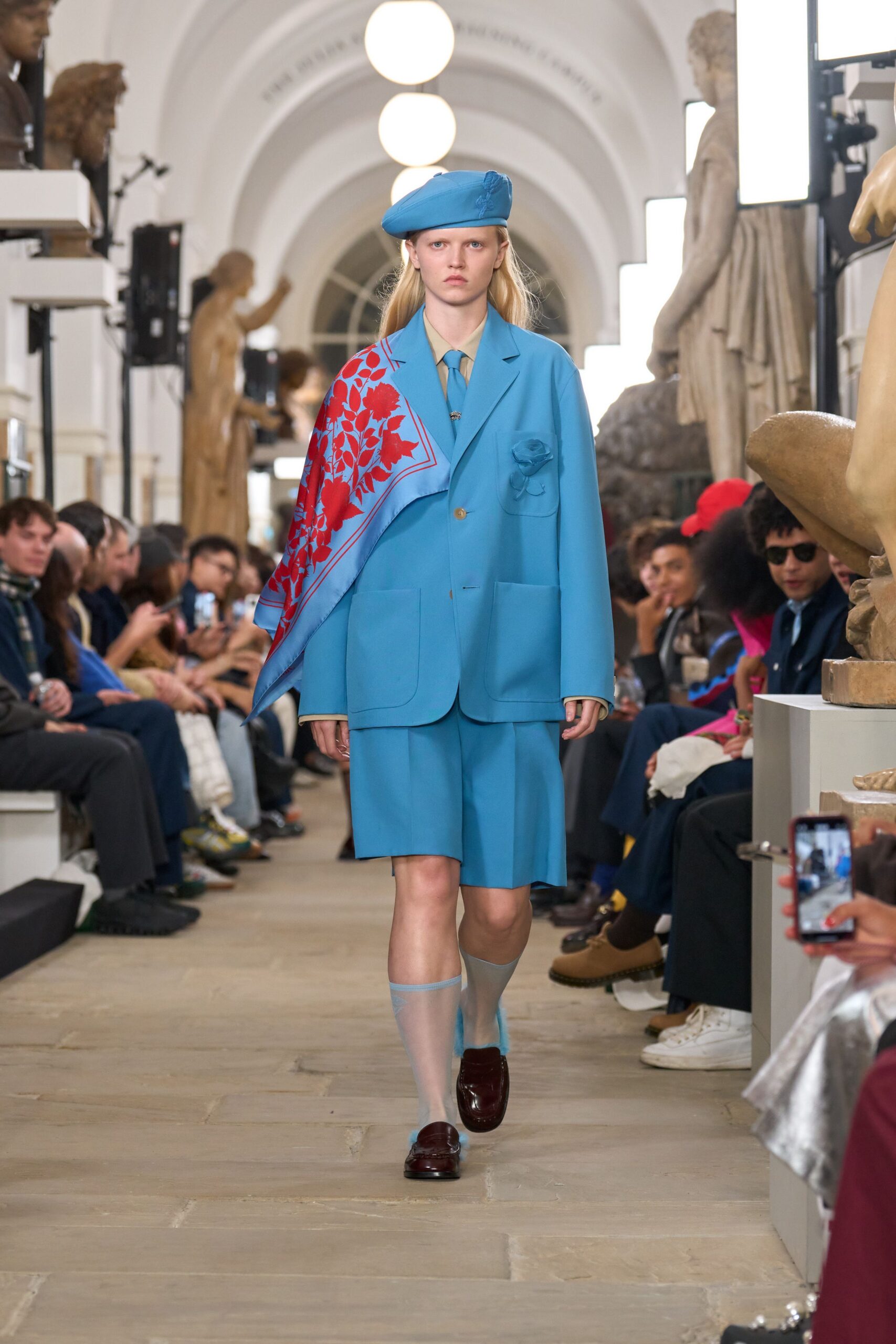 blue tailored suit with red scarf