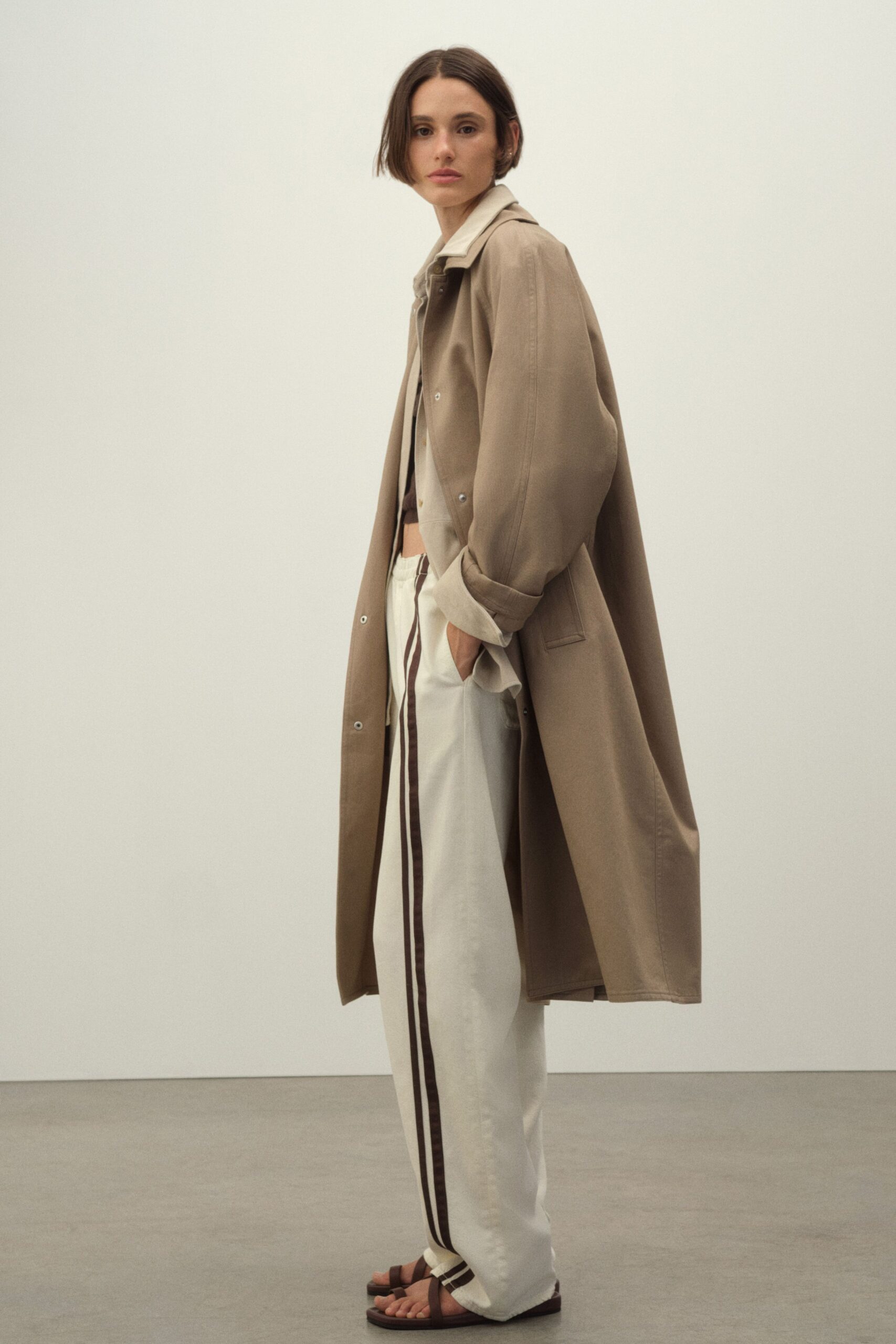 beige coat white pants black shoes