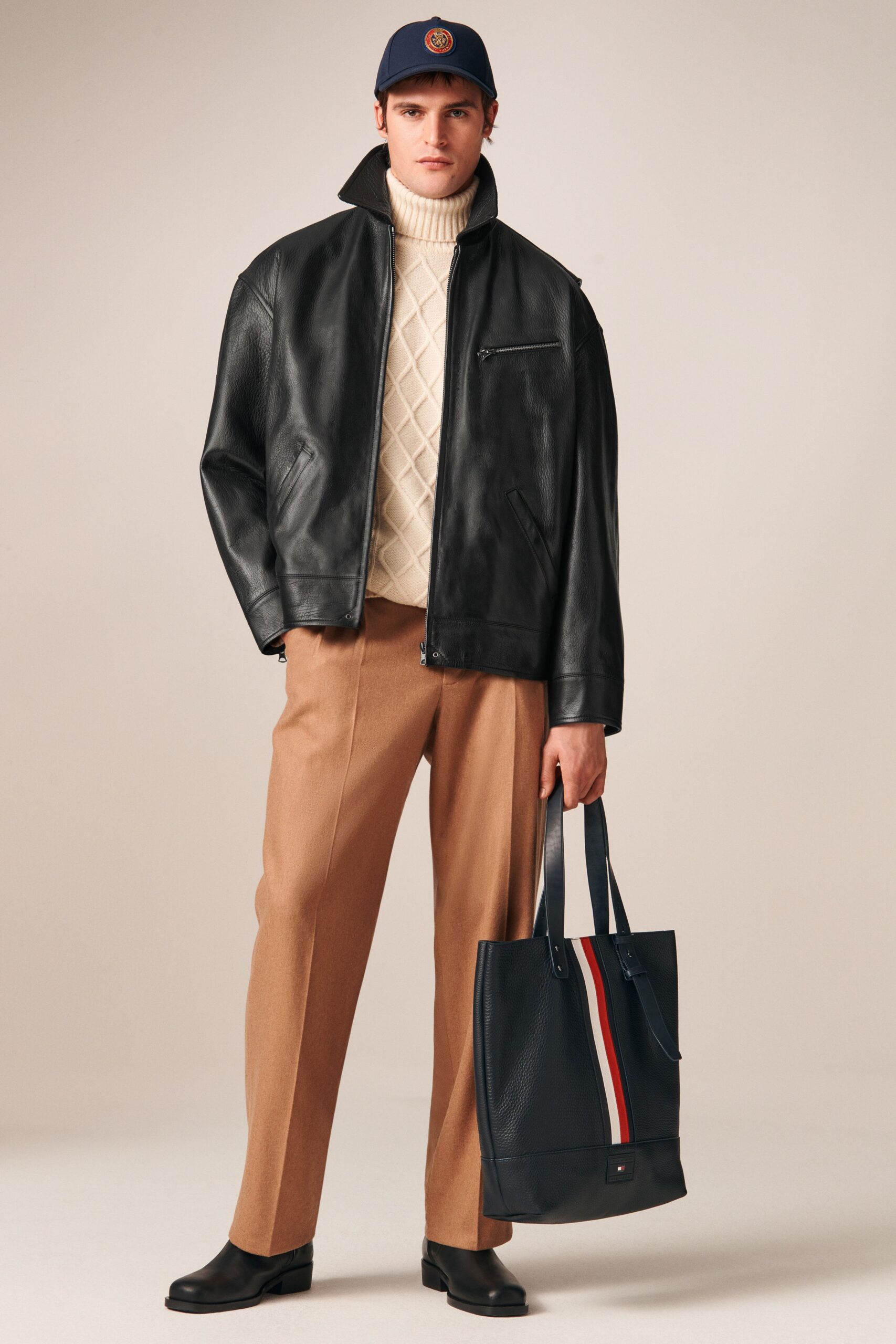 black leather jacket beige sweater
