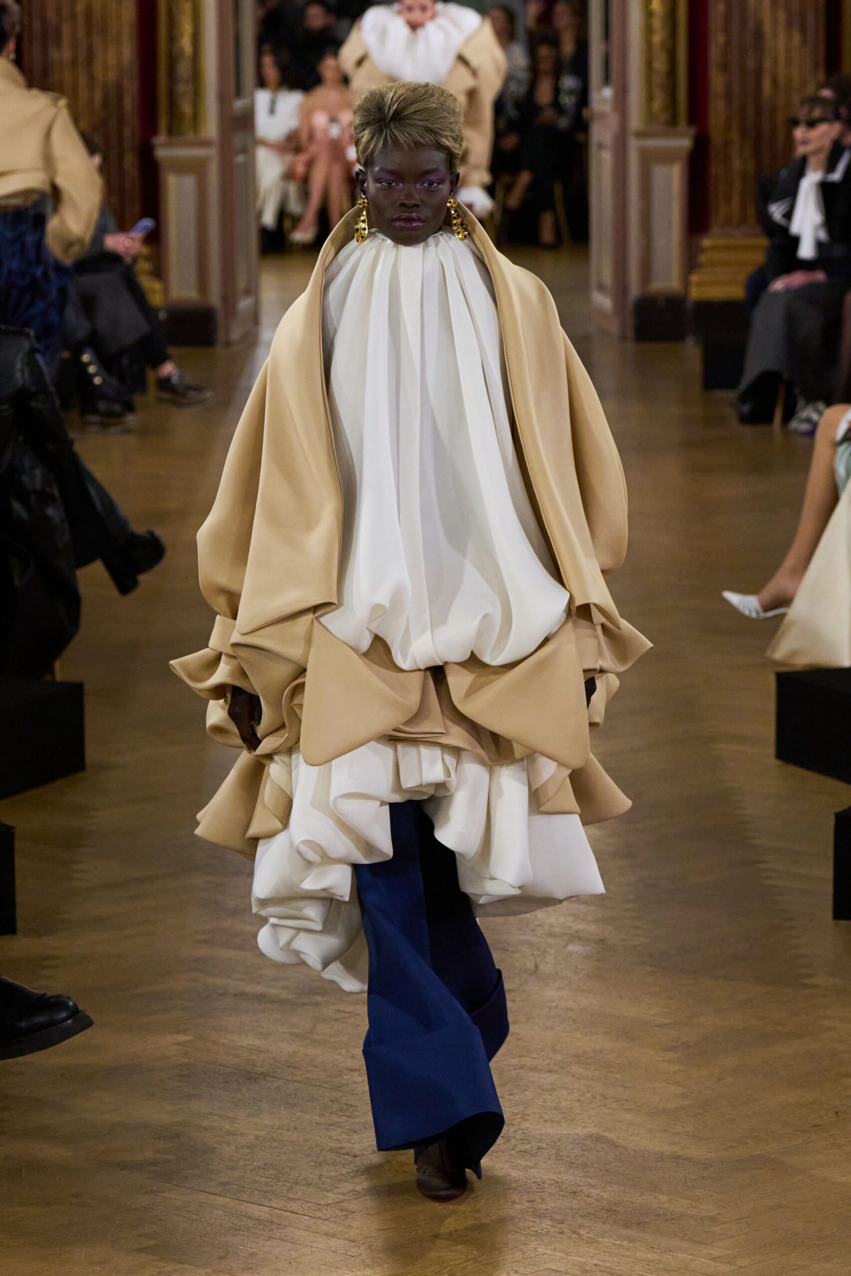 beige and white pleated dress with blue pants