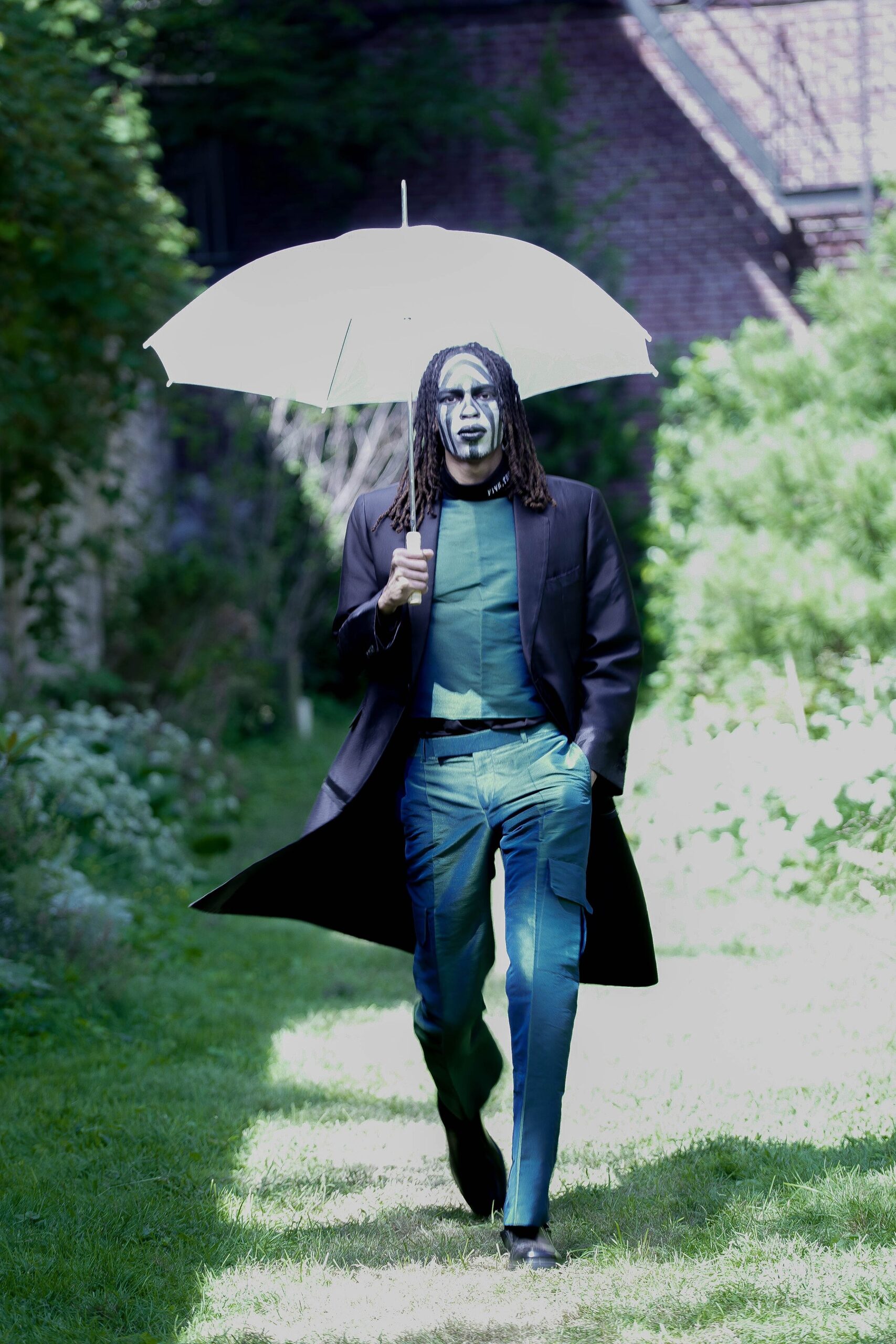 black coat green top blue pants