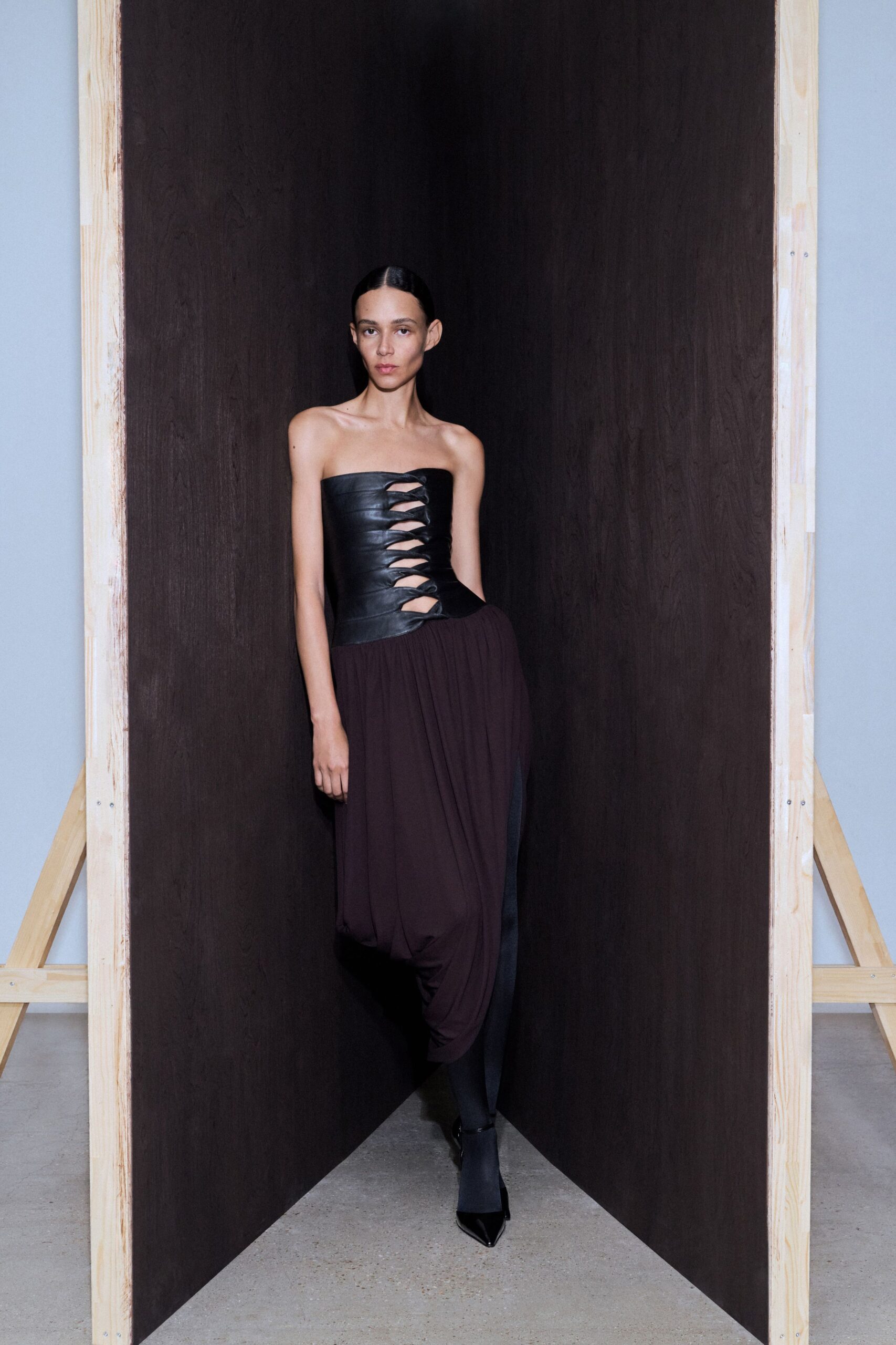 black leather strapless fitted ruched midi dress