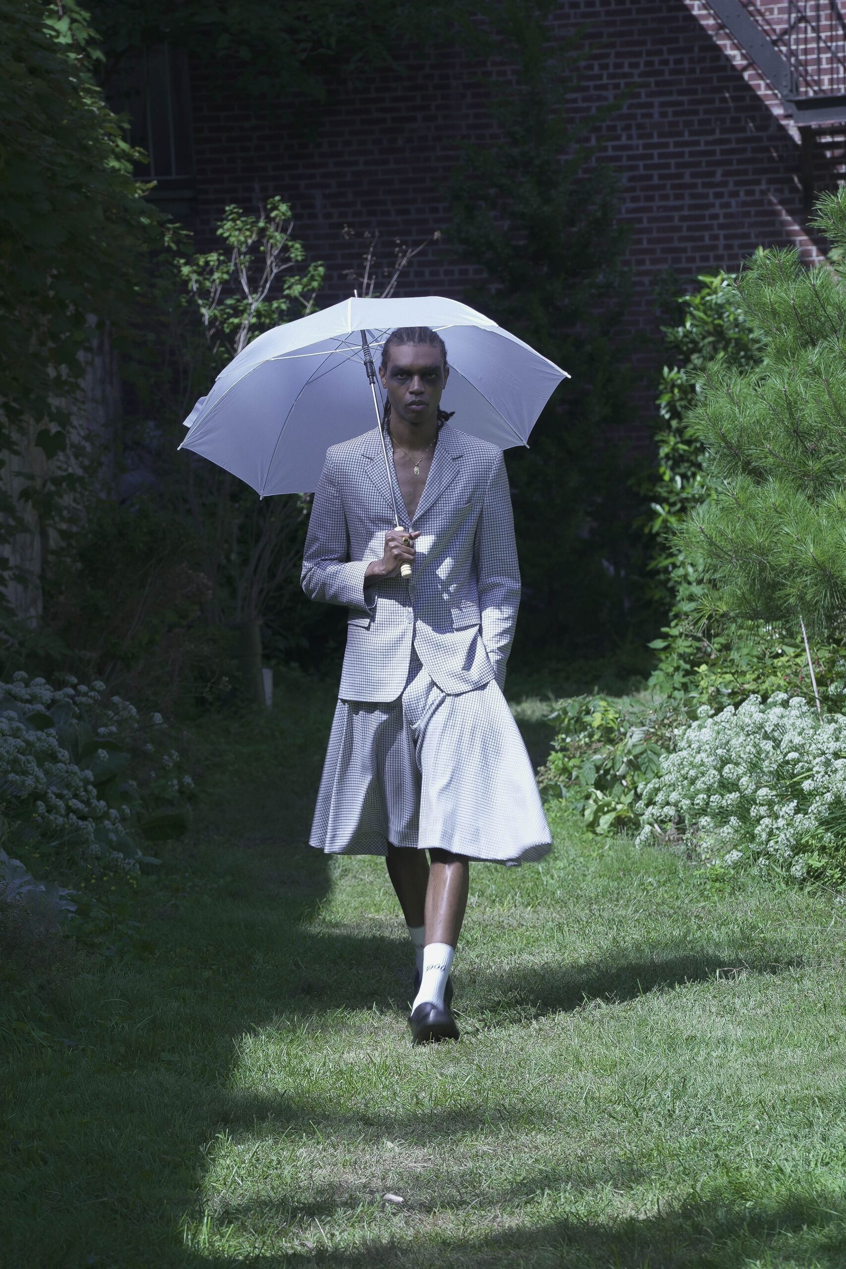 gray pleated suit with umbrella