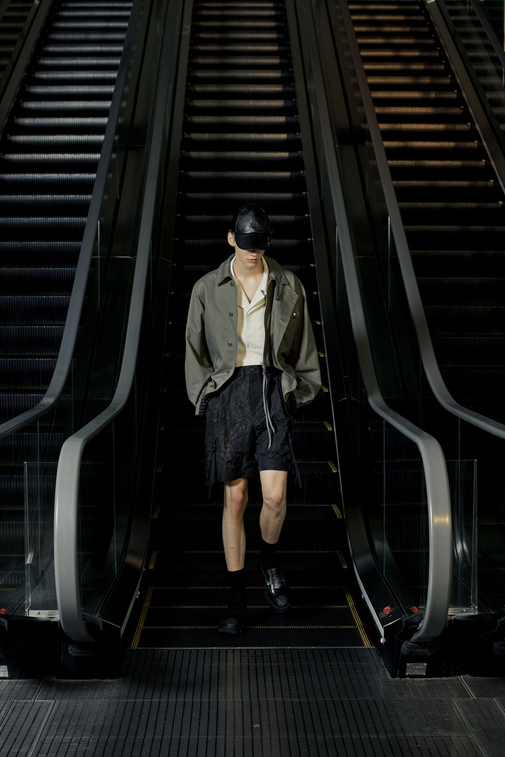 green relaxed jacket with black shorts