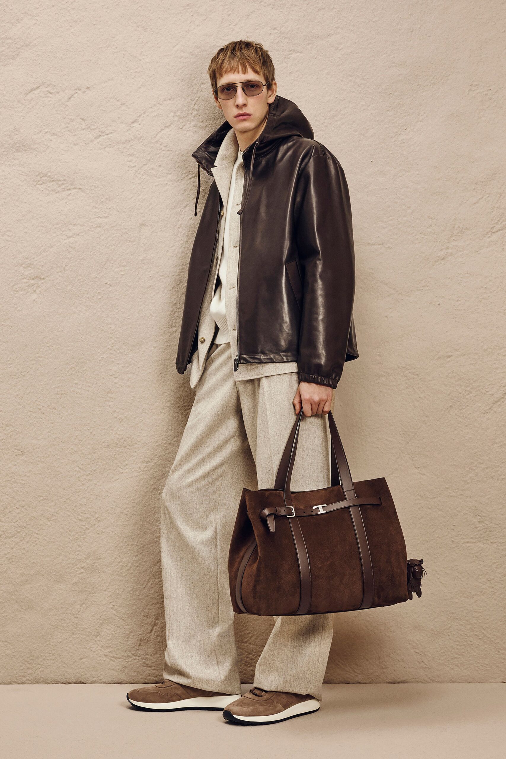 brown leather jacket with beige pants