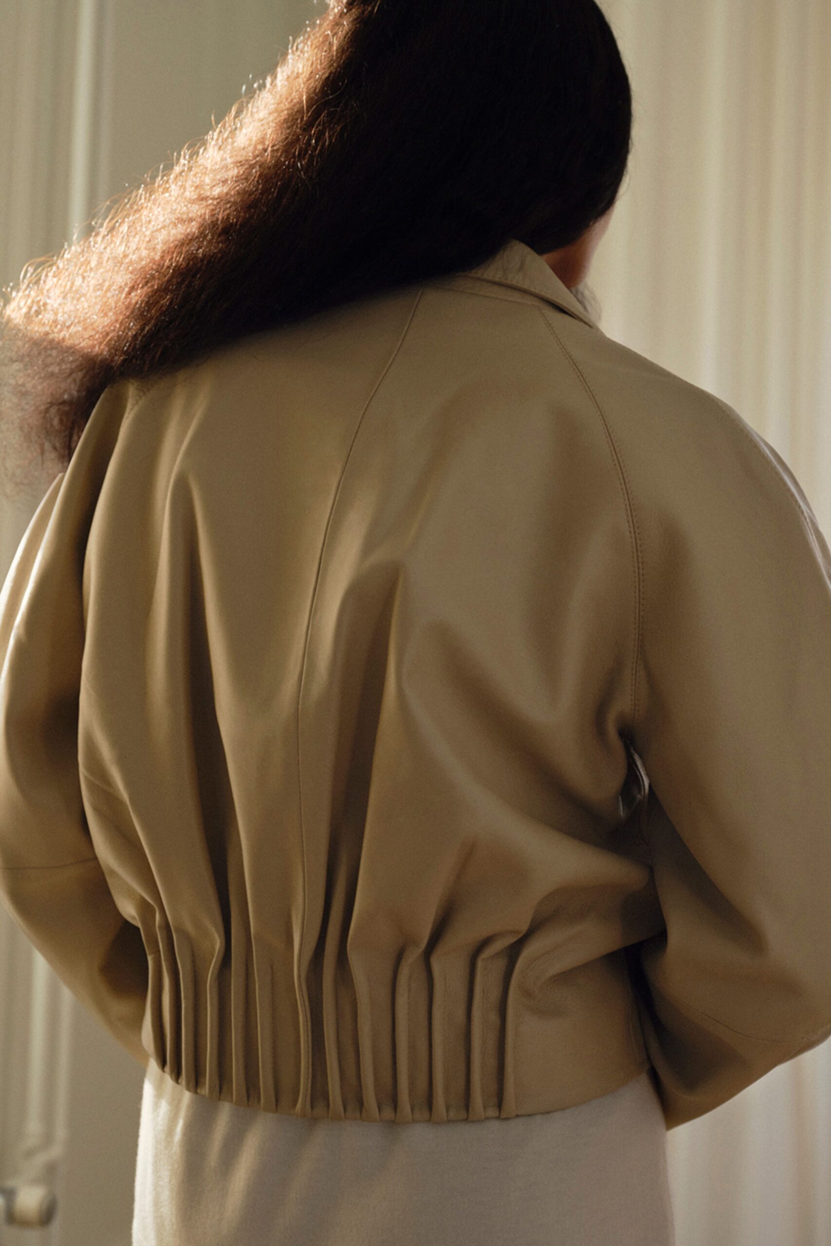 beige leather long-sleeve collared fitted pleated jacket