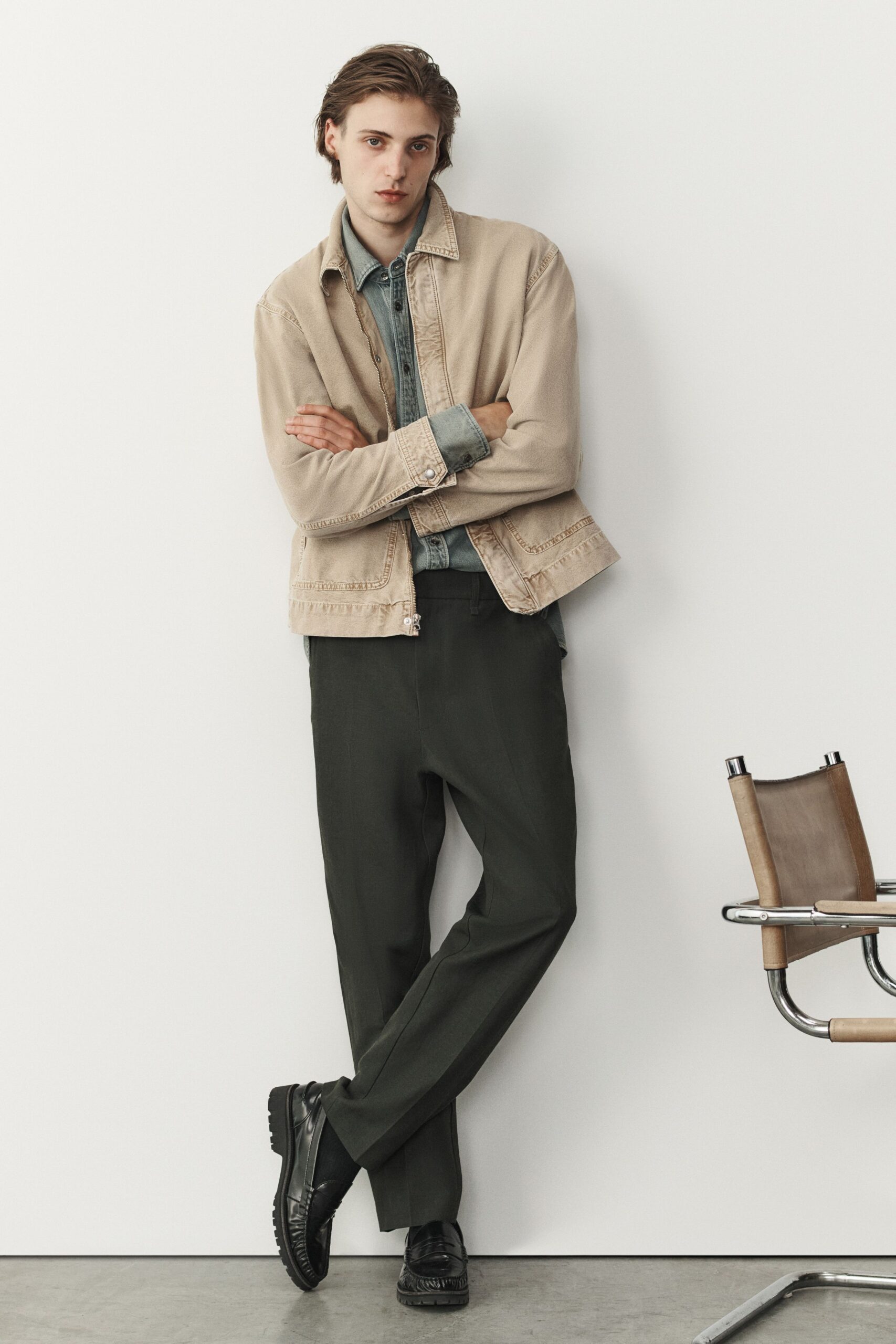 beige jacket blue shirt black pants