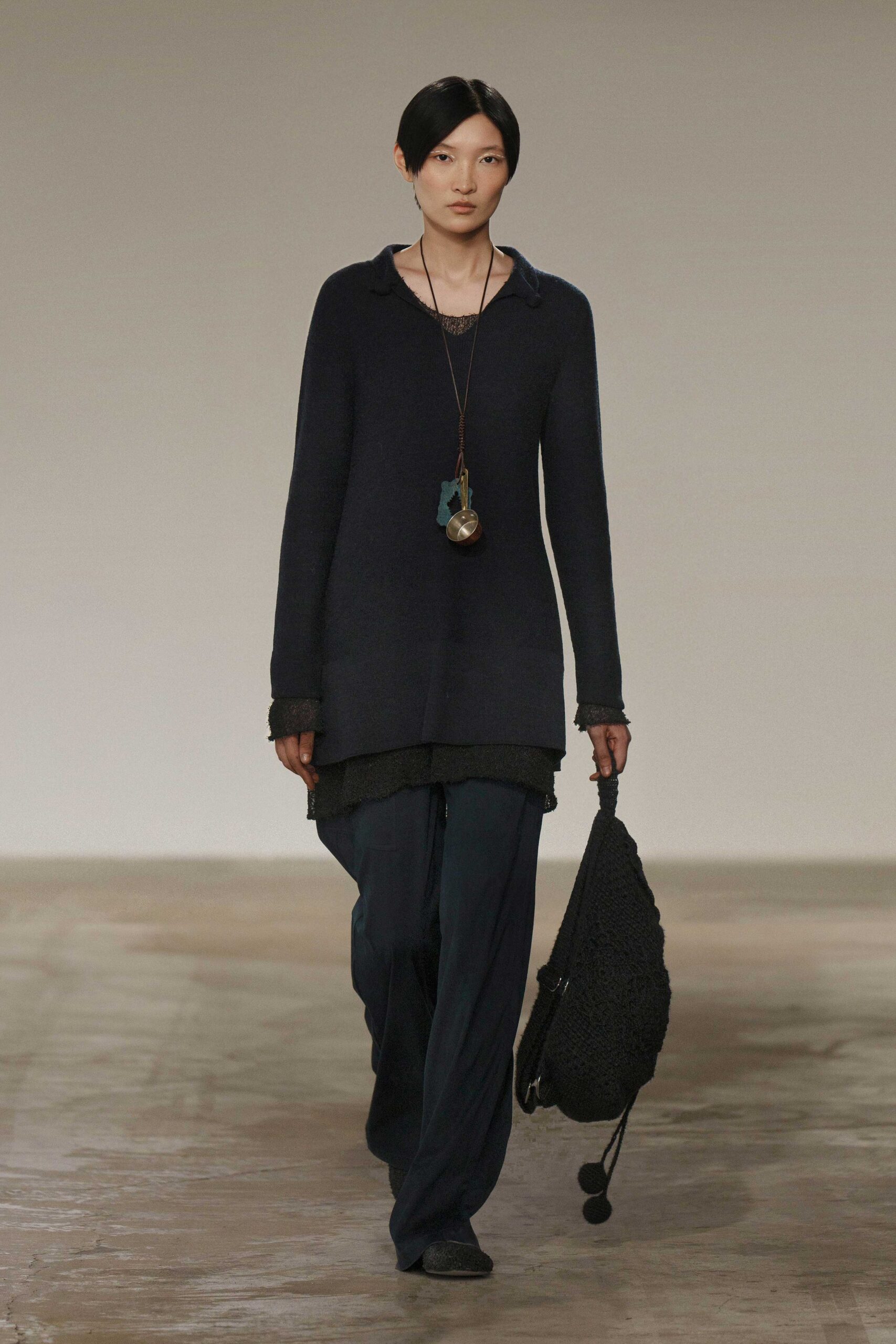 black relaxed top with blue pants