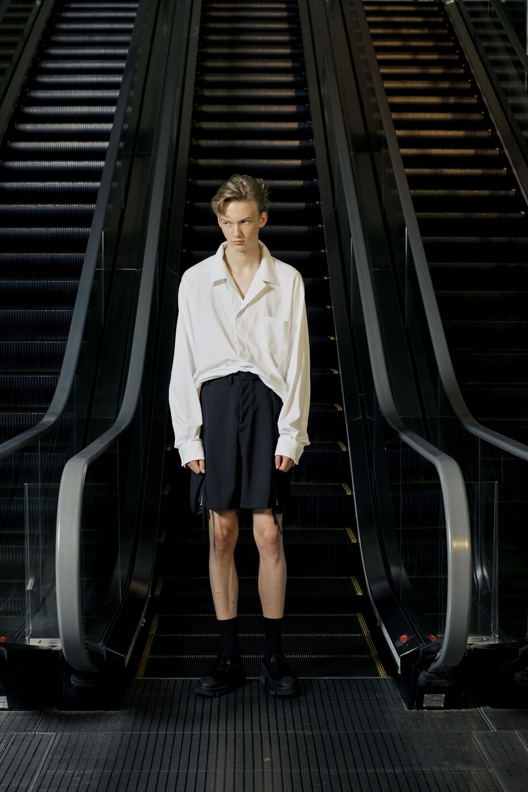 white relaxed shirt with black shorts
