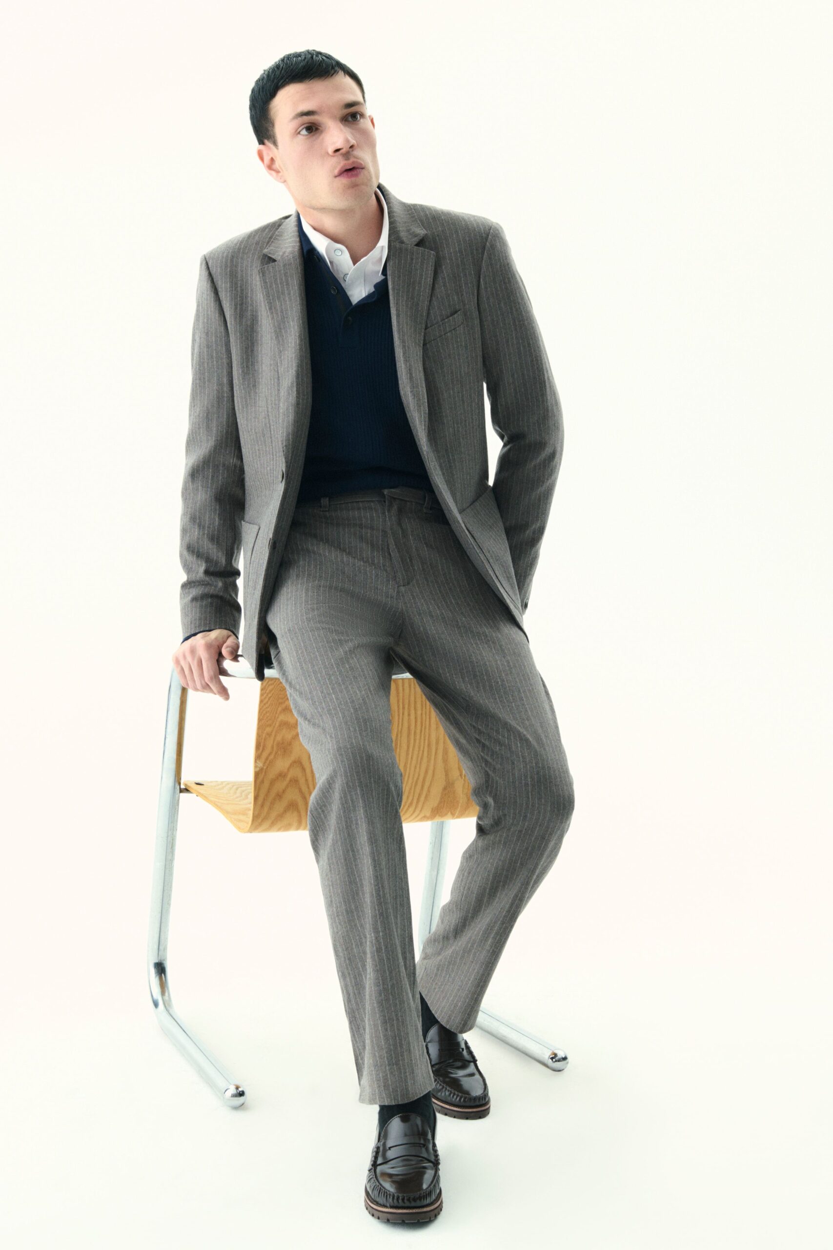 gray tailored suit with blue sweater