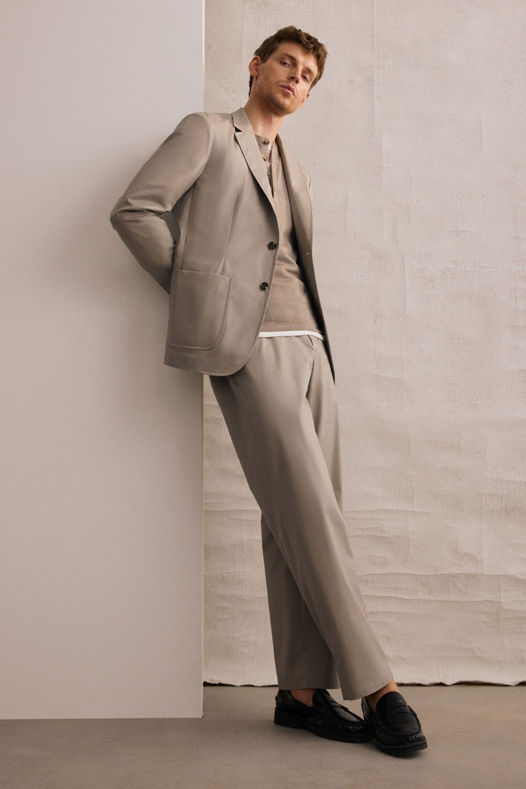 beige tailored suit with gray shirt