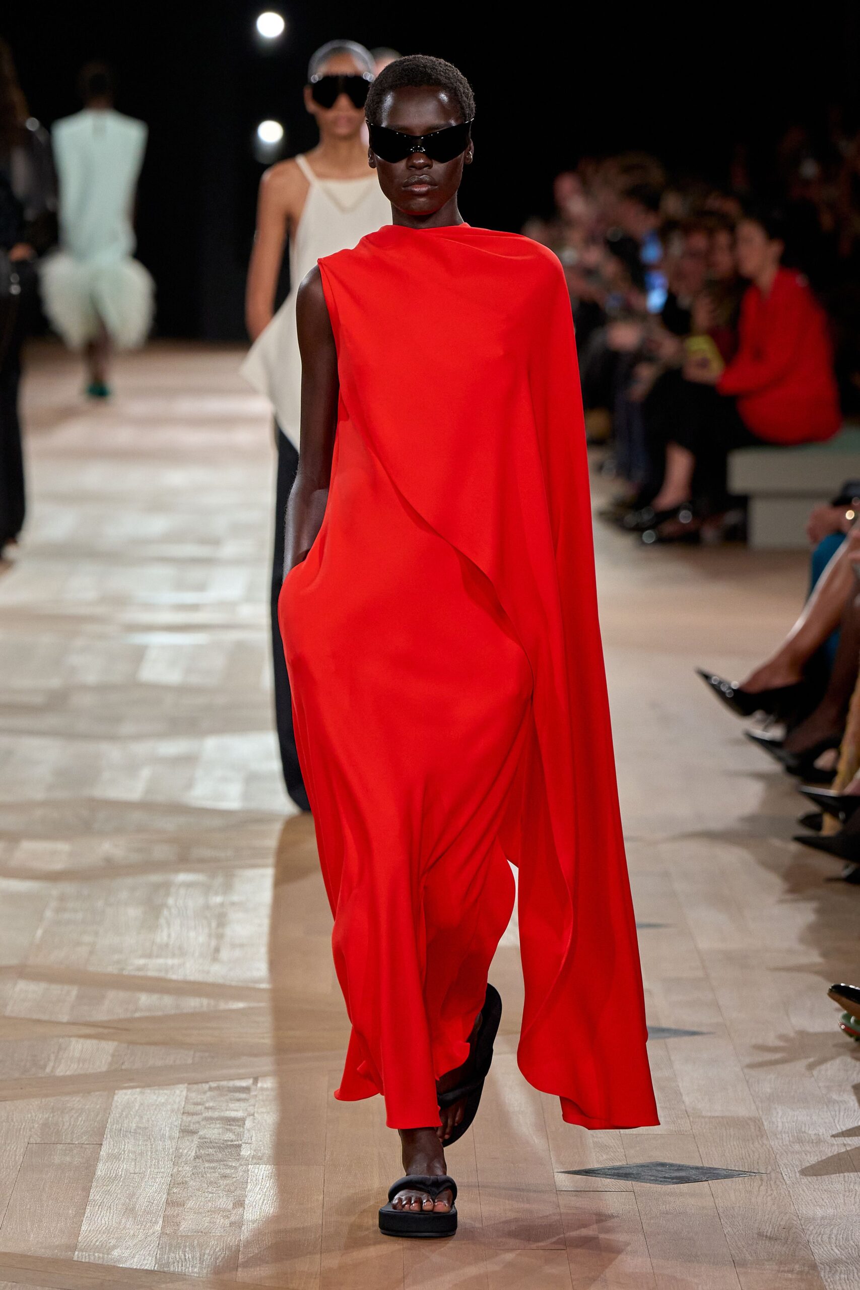 red draped gown with black shoes