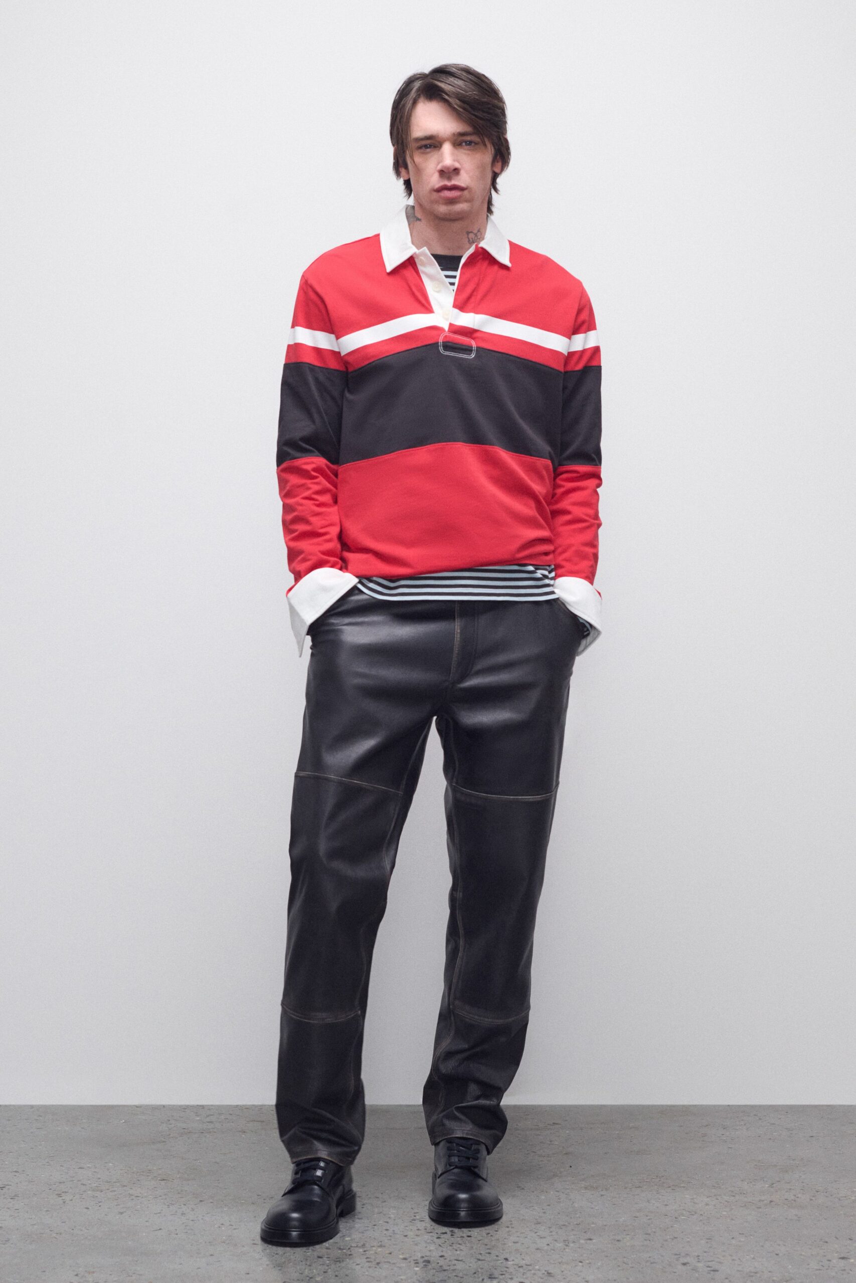 red and black color-blocked shirt with leather pants