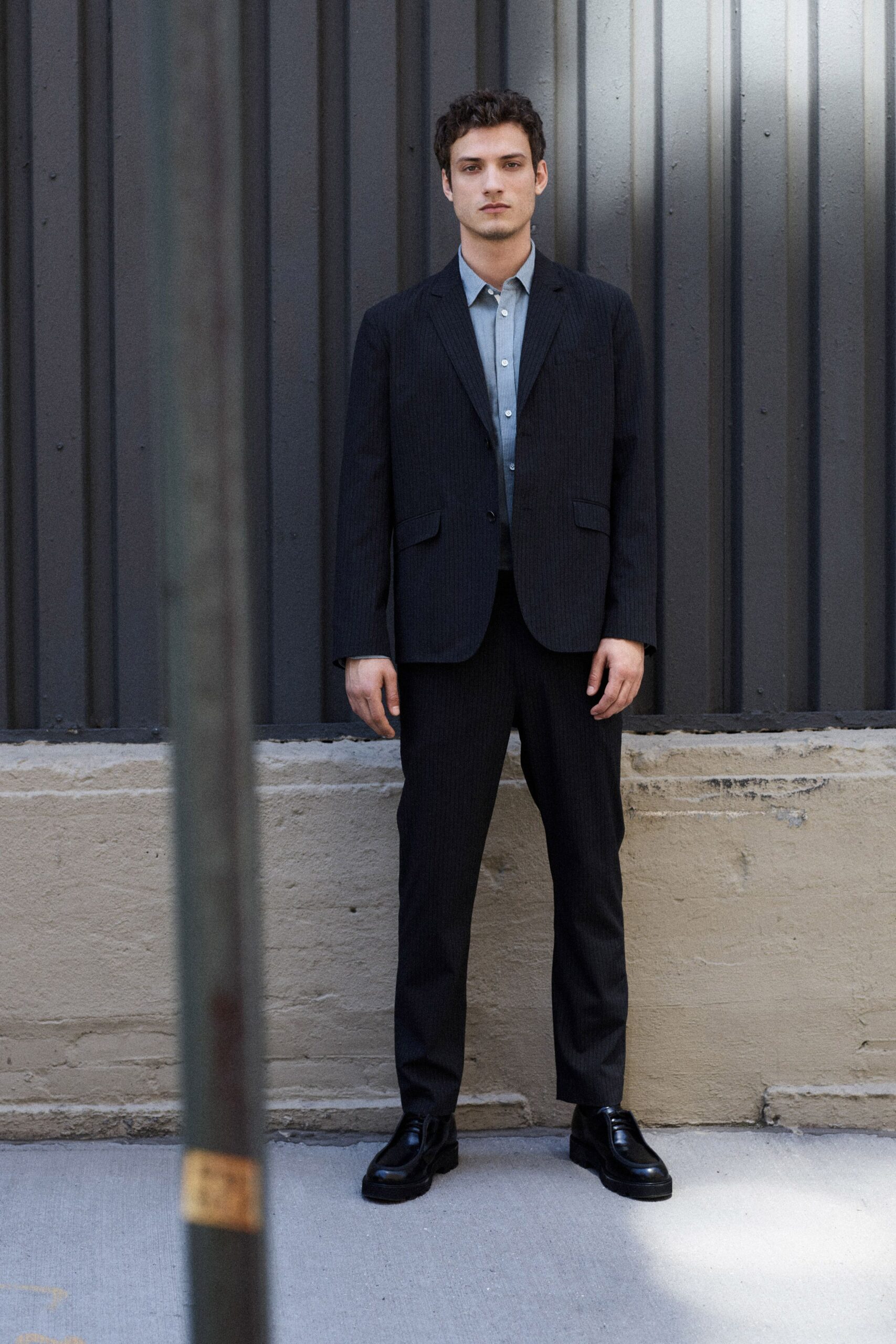 black tailored suit with gray shirt