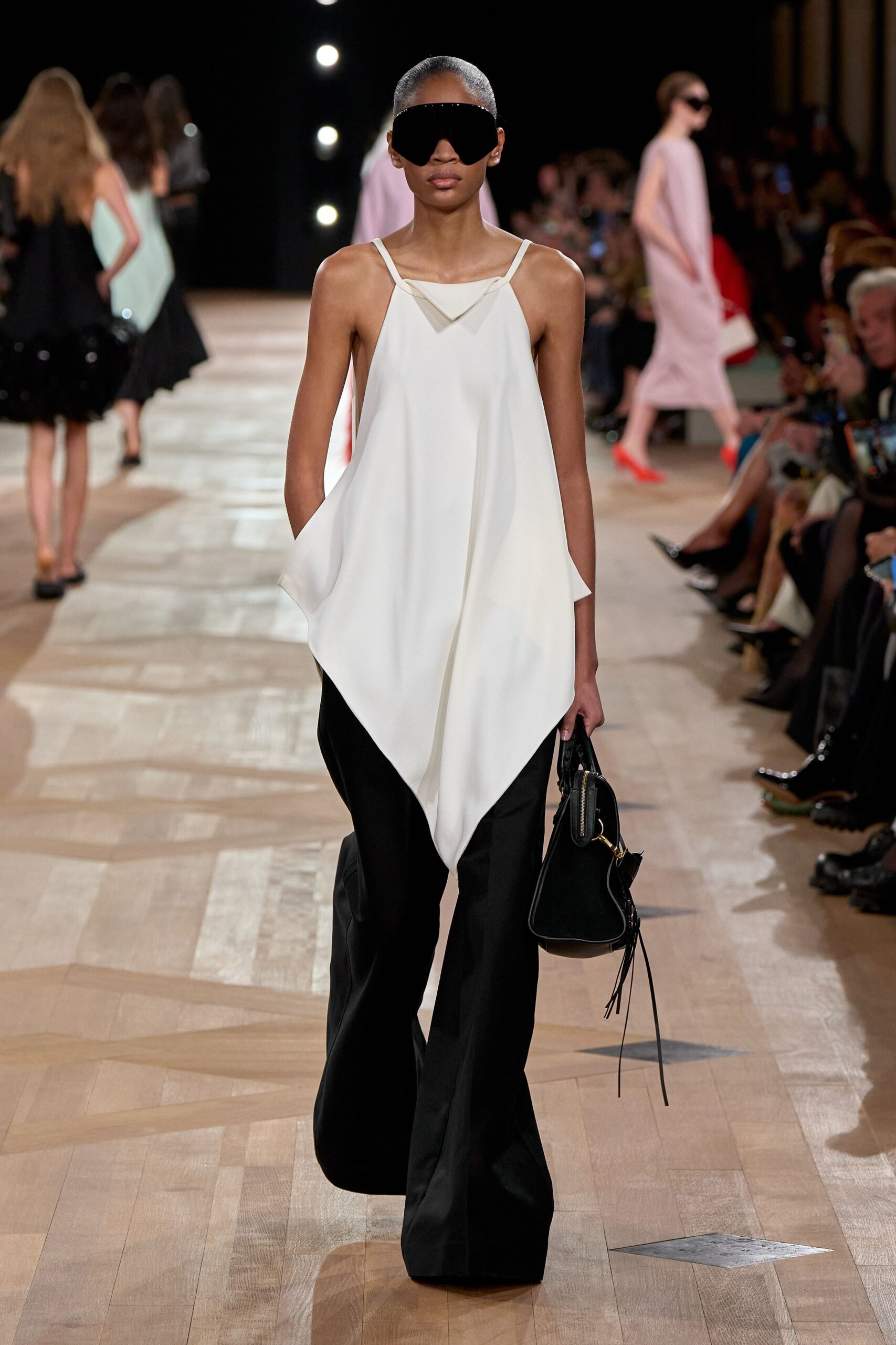 white asymmetric top with black pants