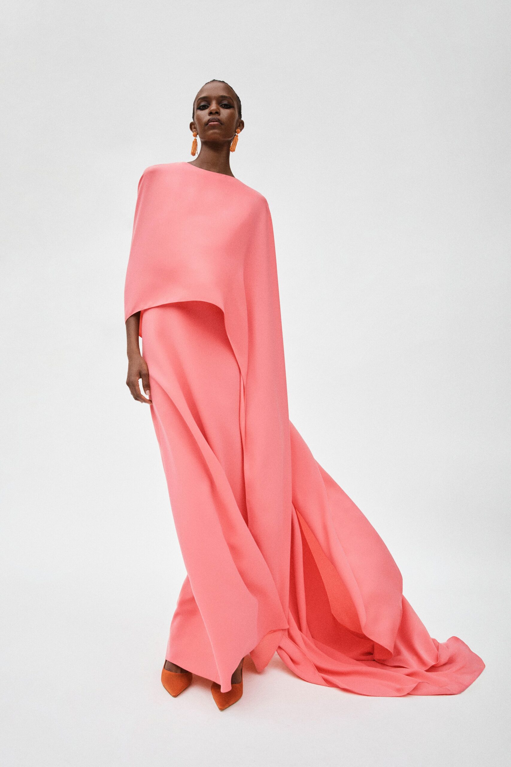 pink silk flowing gown with orange shoes