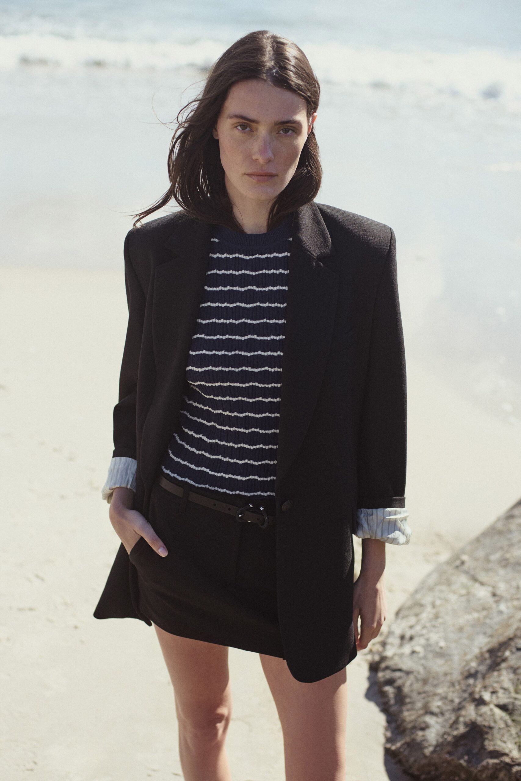 black blazer with striped top and mini skirt