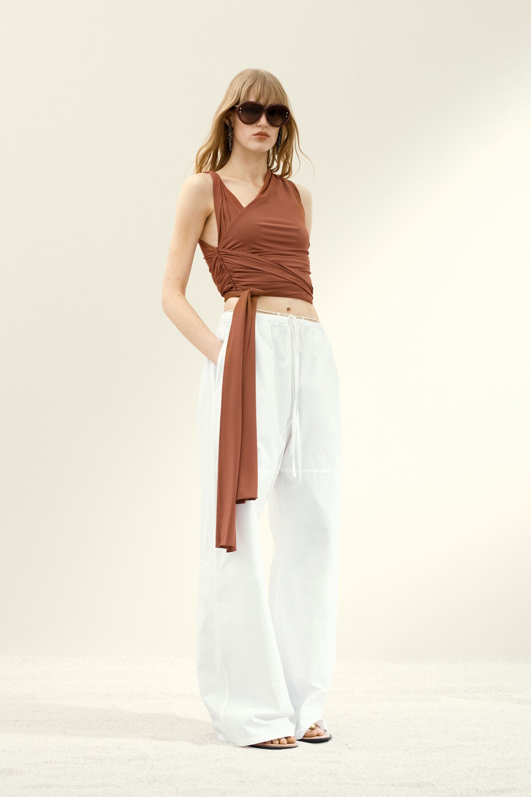 brown fitted top with white pants