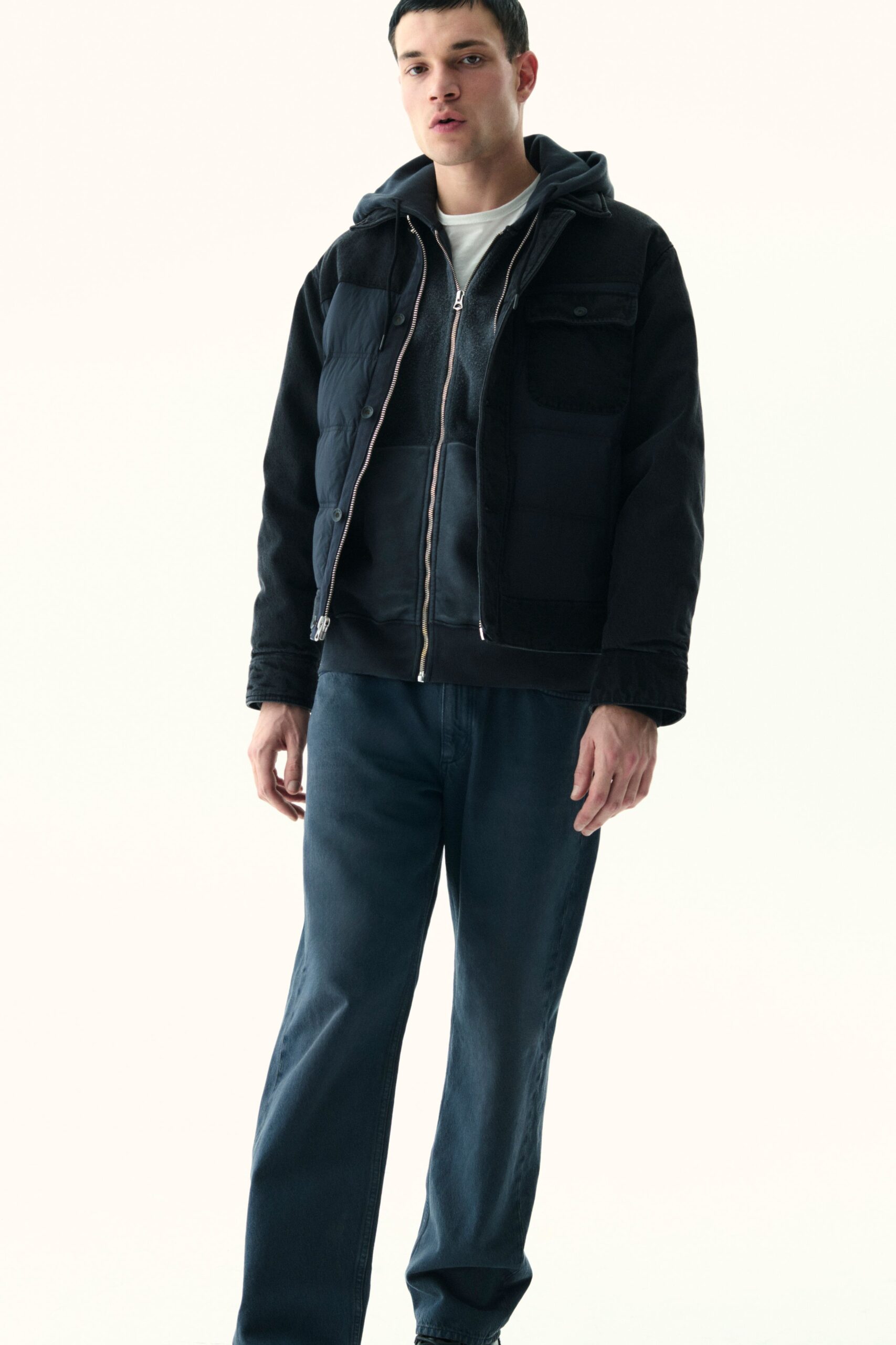 black jacket gray hoodie white t-shirt blue pants