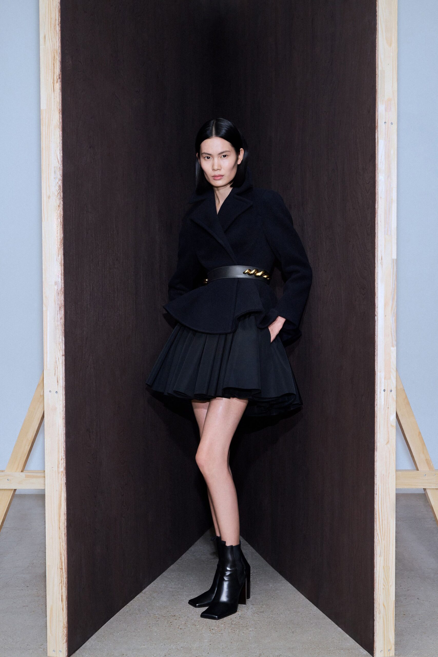 black structured blazer with pleated skirt