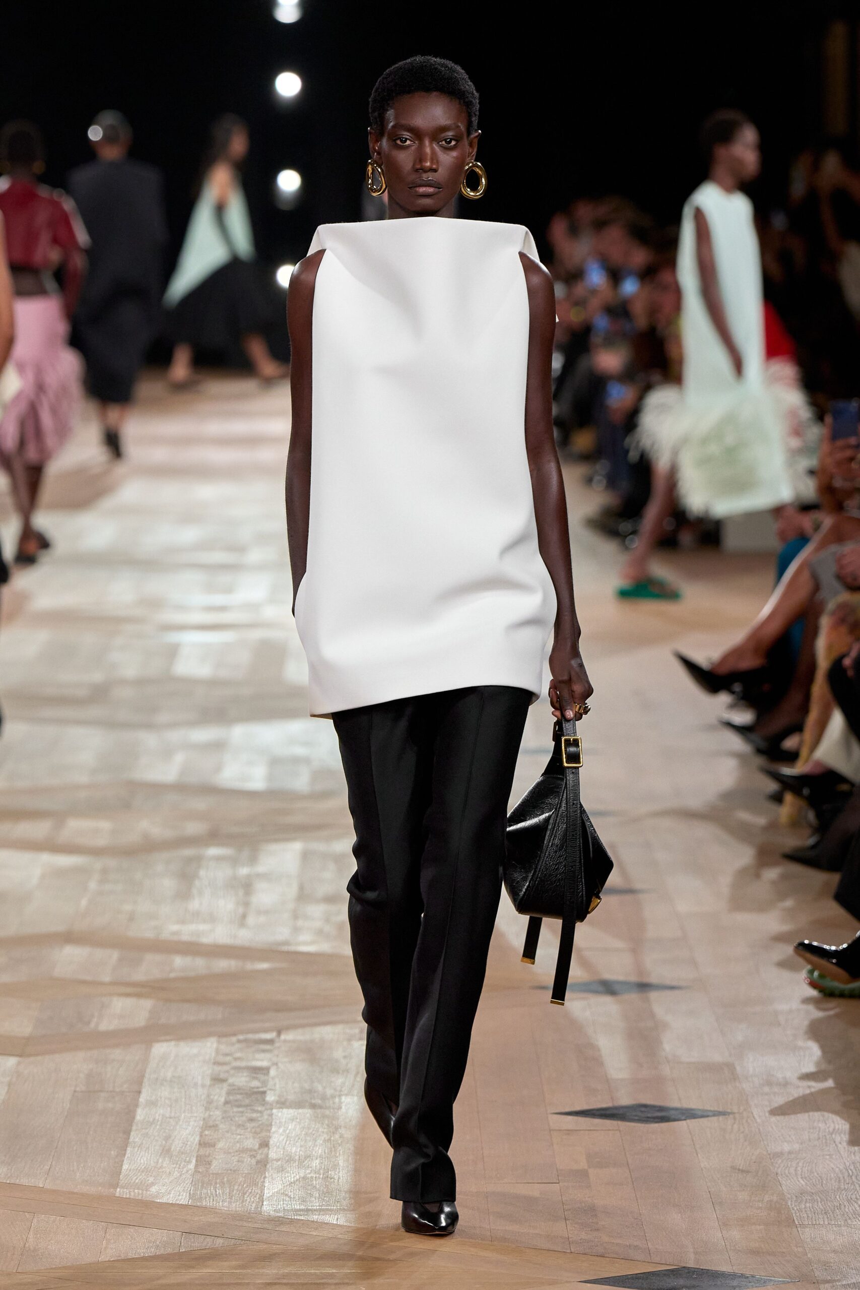 white sleeveless top with black pants