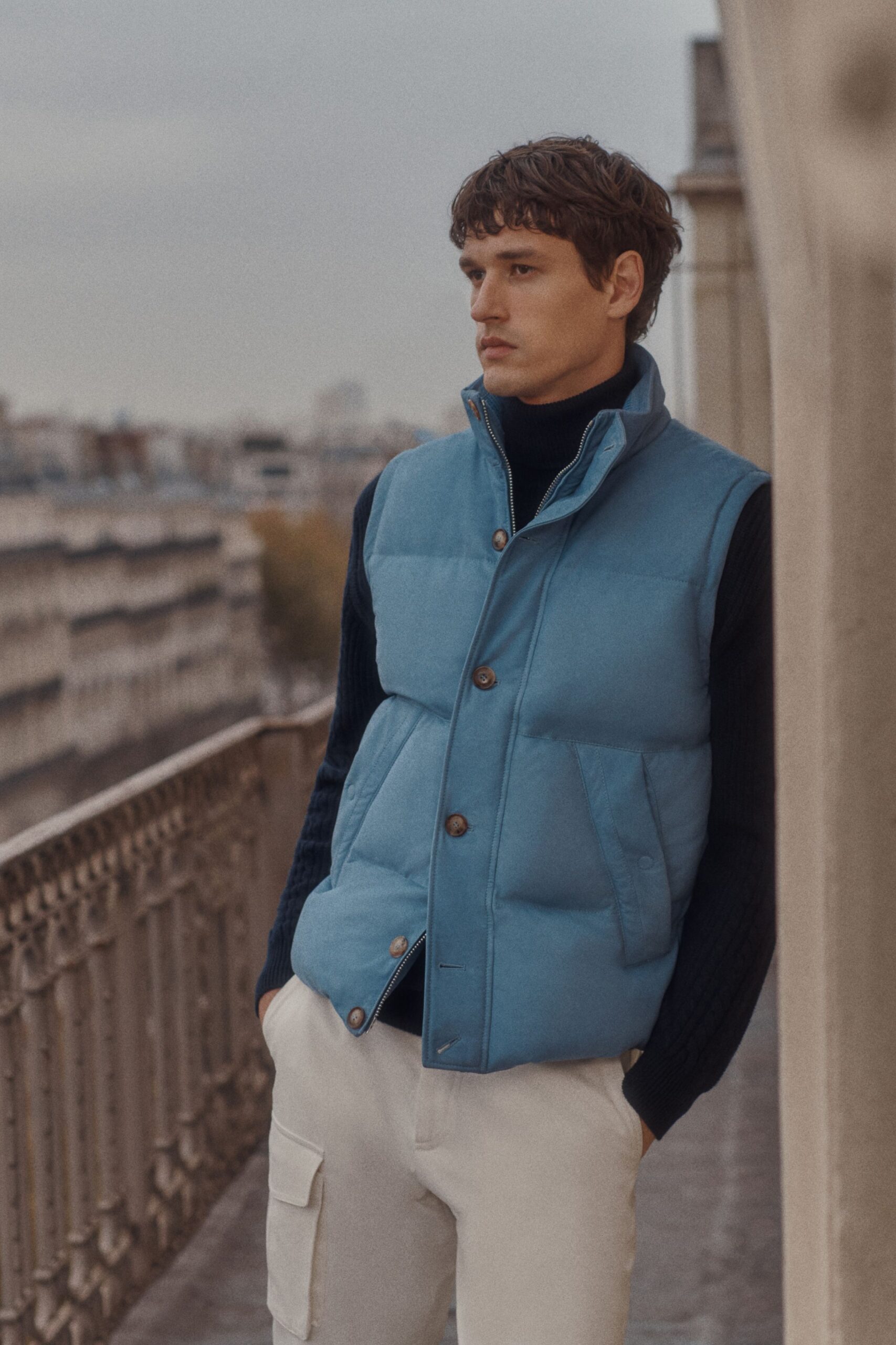 blue padded vest with black sweater