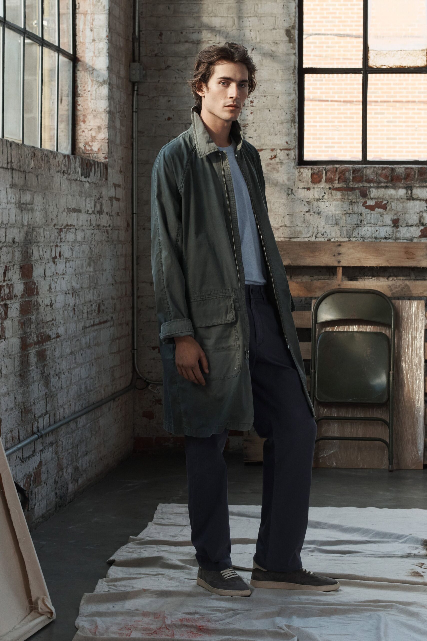 green coat gray t-shirt blue pants