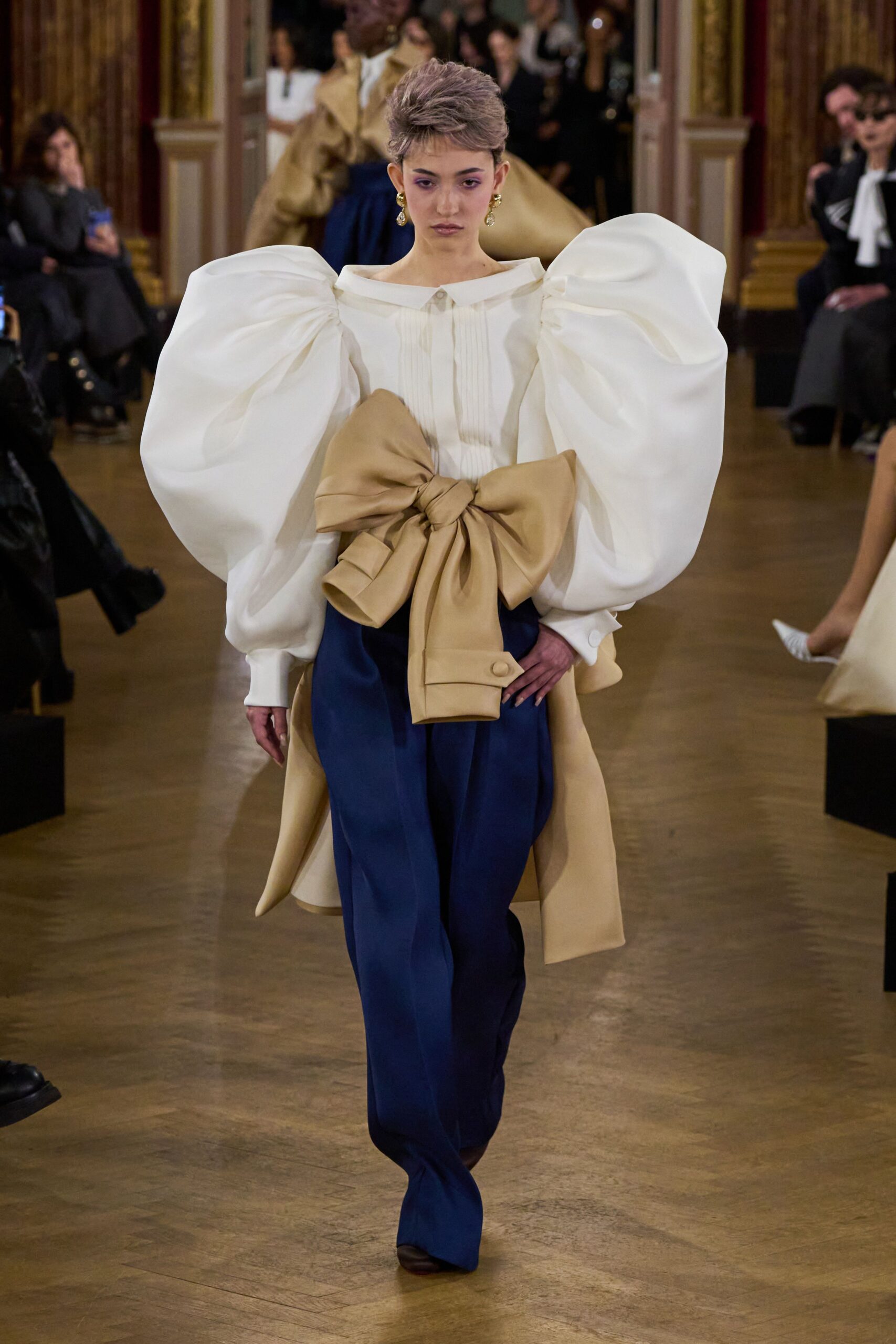 white blouse with puffed sleeves and blue pants