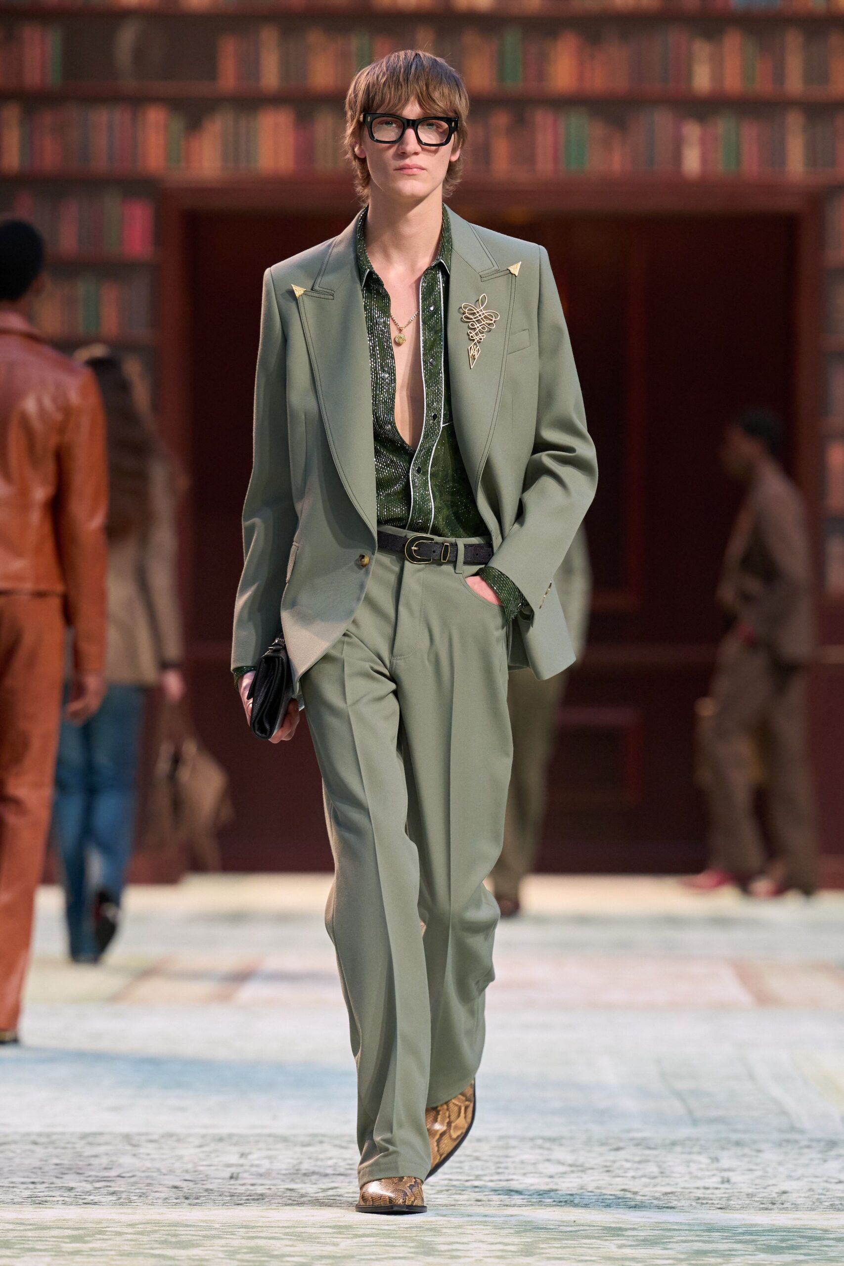 green tailored suit with black shirt