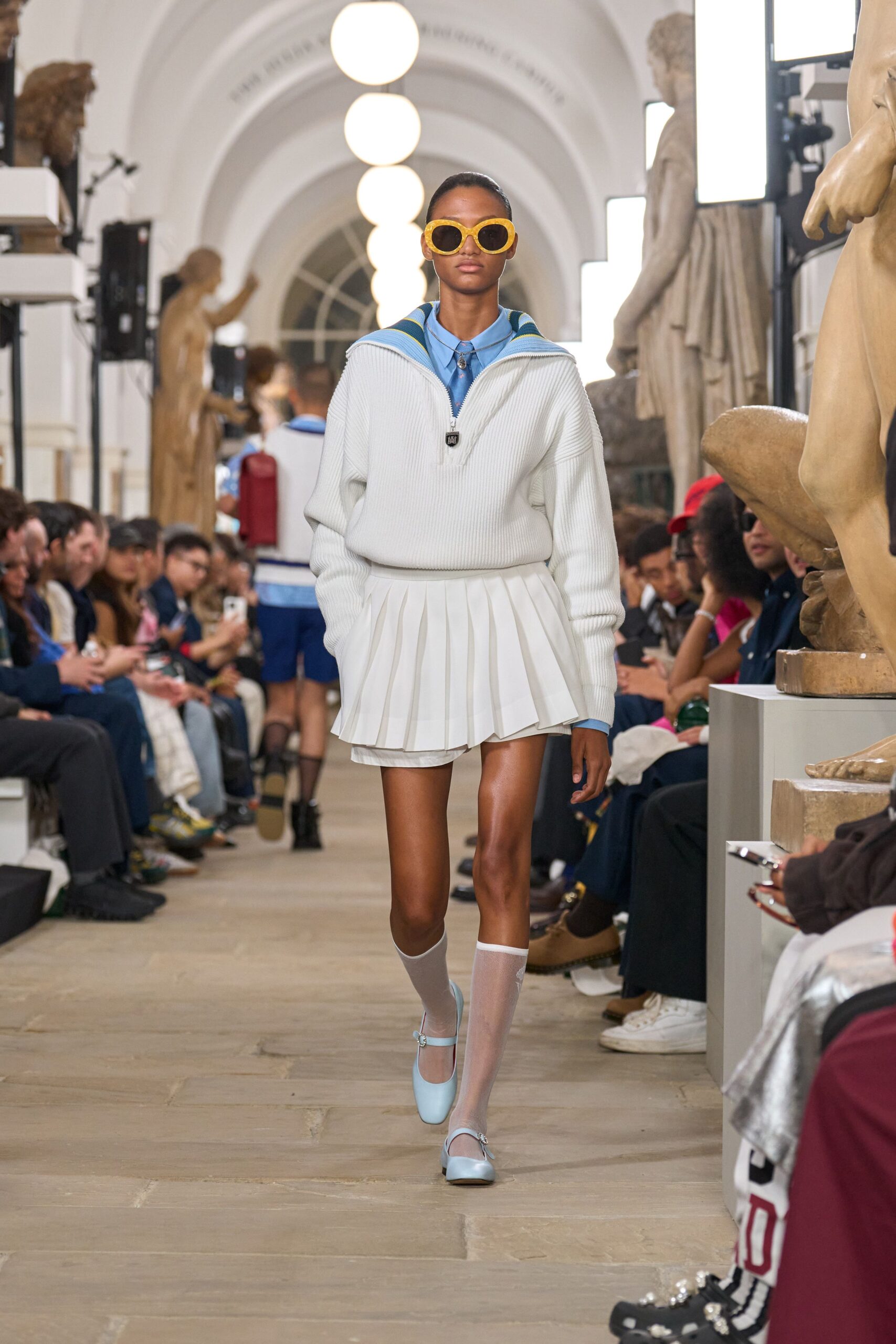 white sweater and pleated skirt