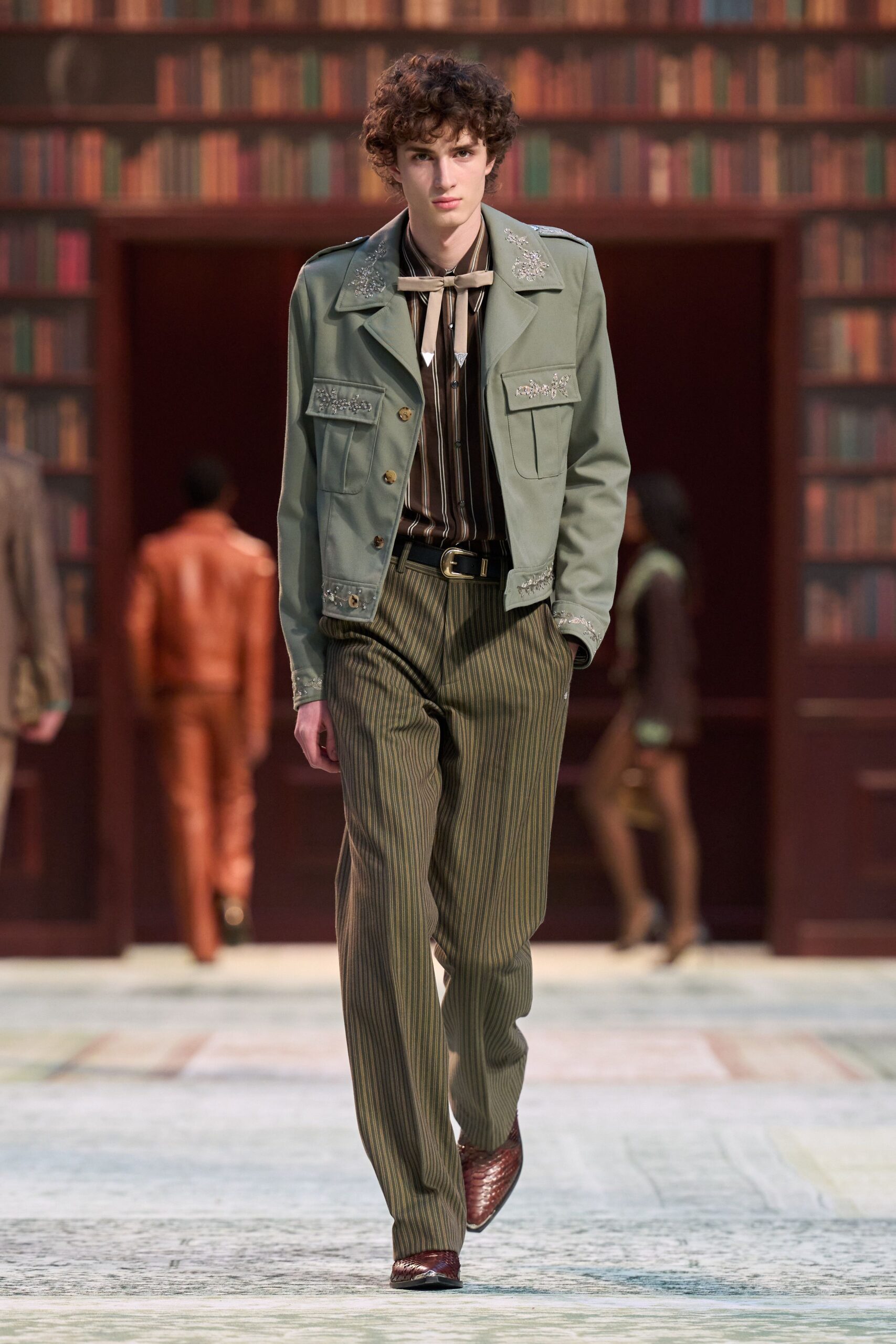 green jacket with striped shirt and tailored pants