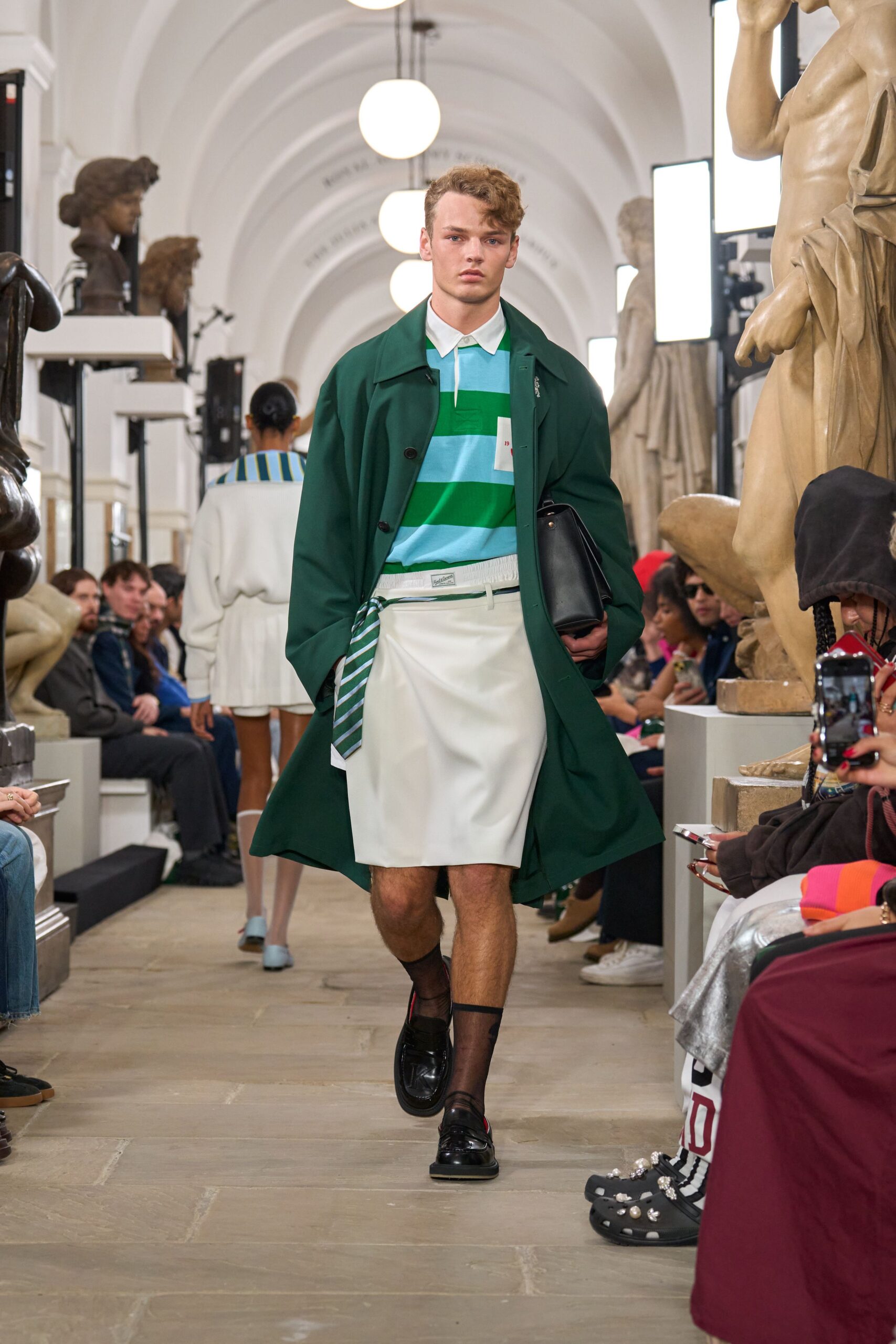 green coat with striped shirt