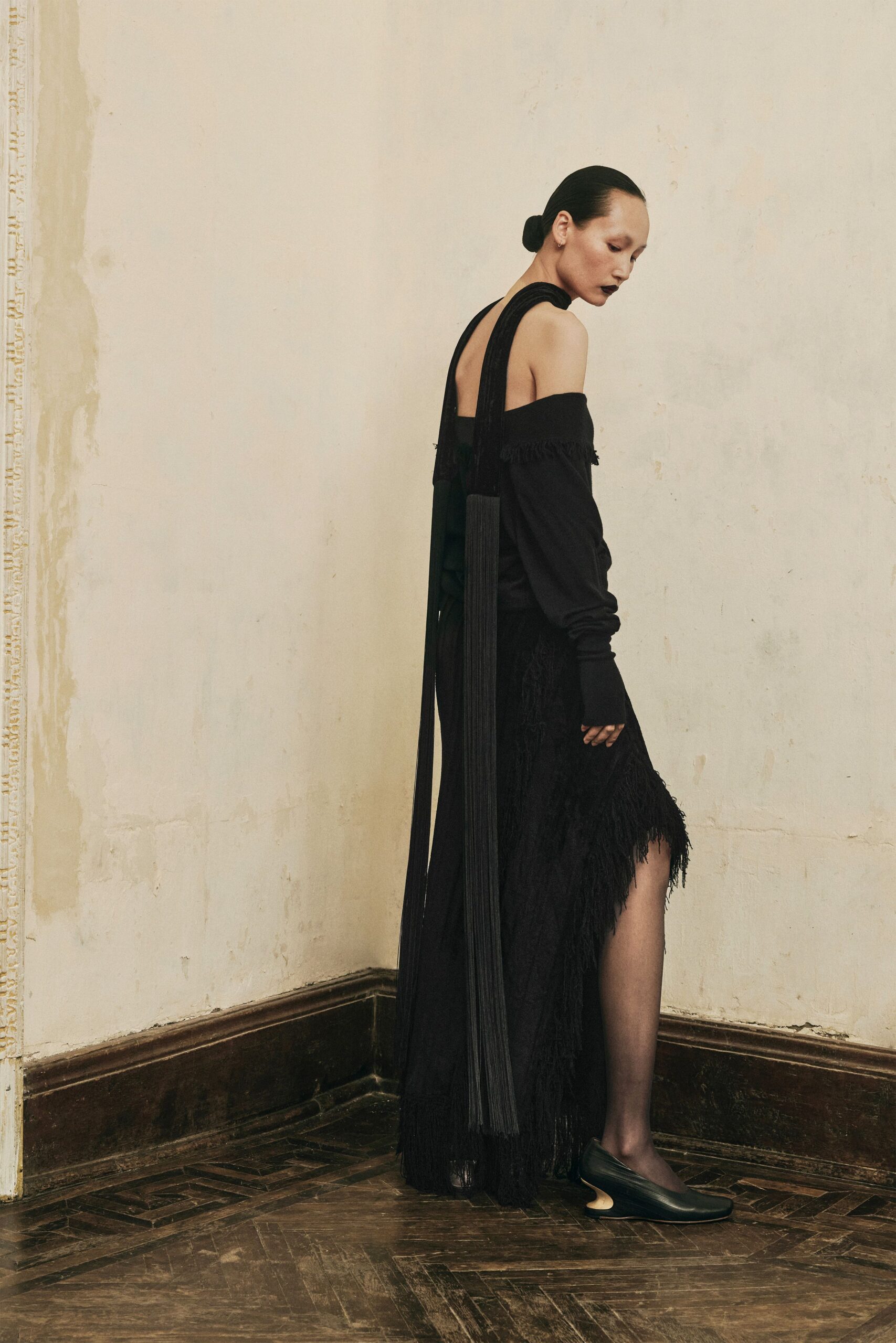 black off-shoulder gown with fringe