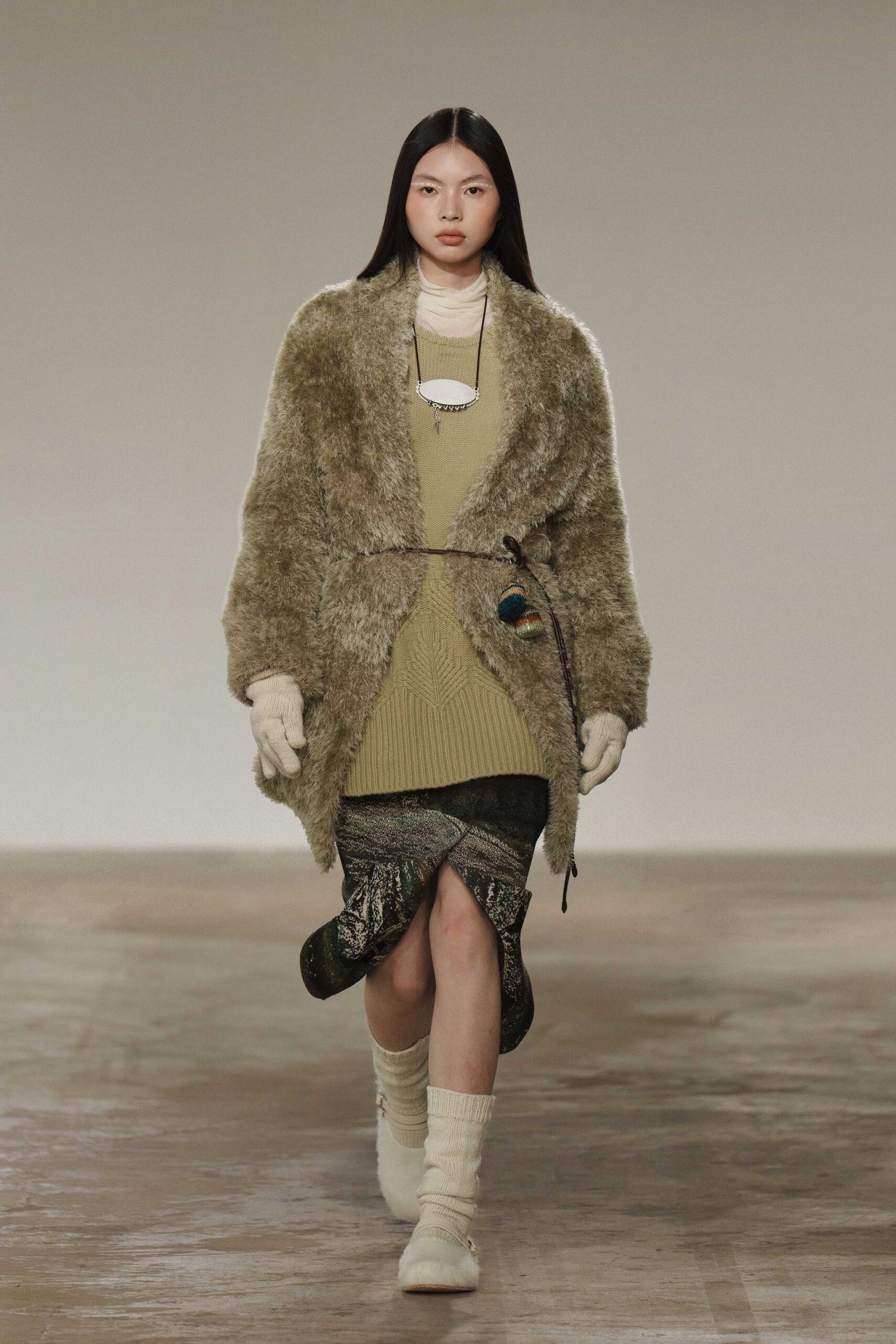 beige faux-fur coat with green knit dress