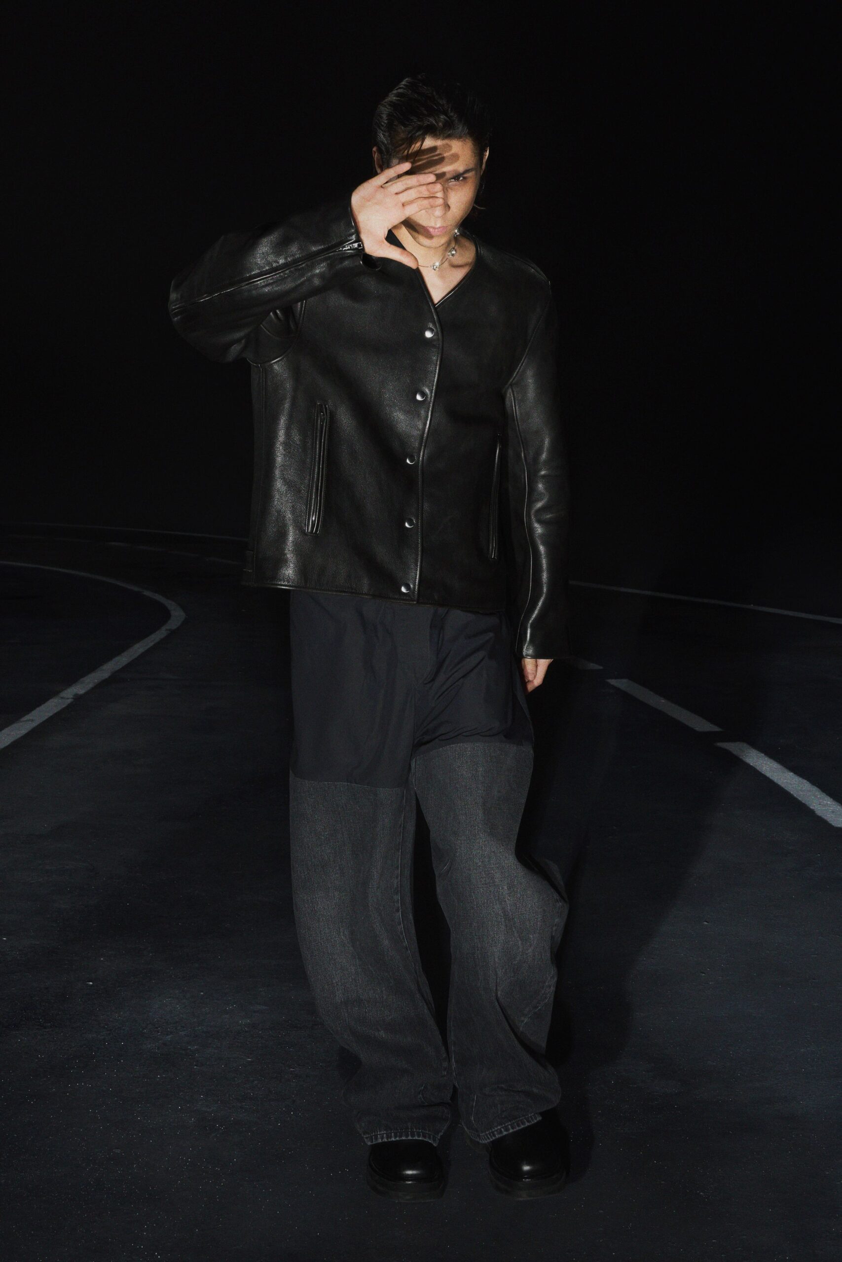 black leather jacket with gray pants