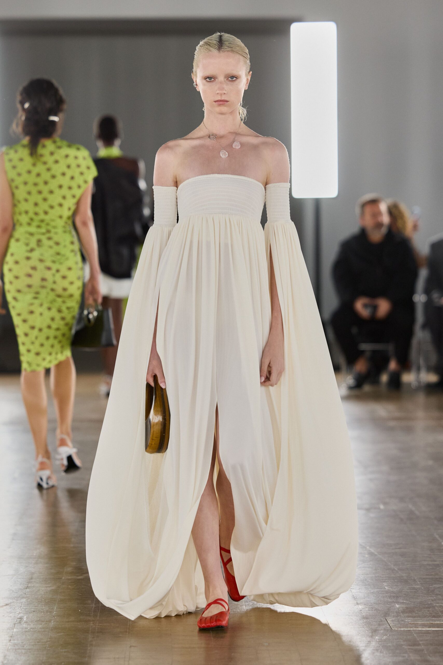 white silk sleeveless off-shoulder fitted draped flowing gown
